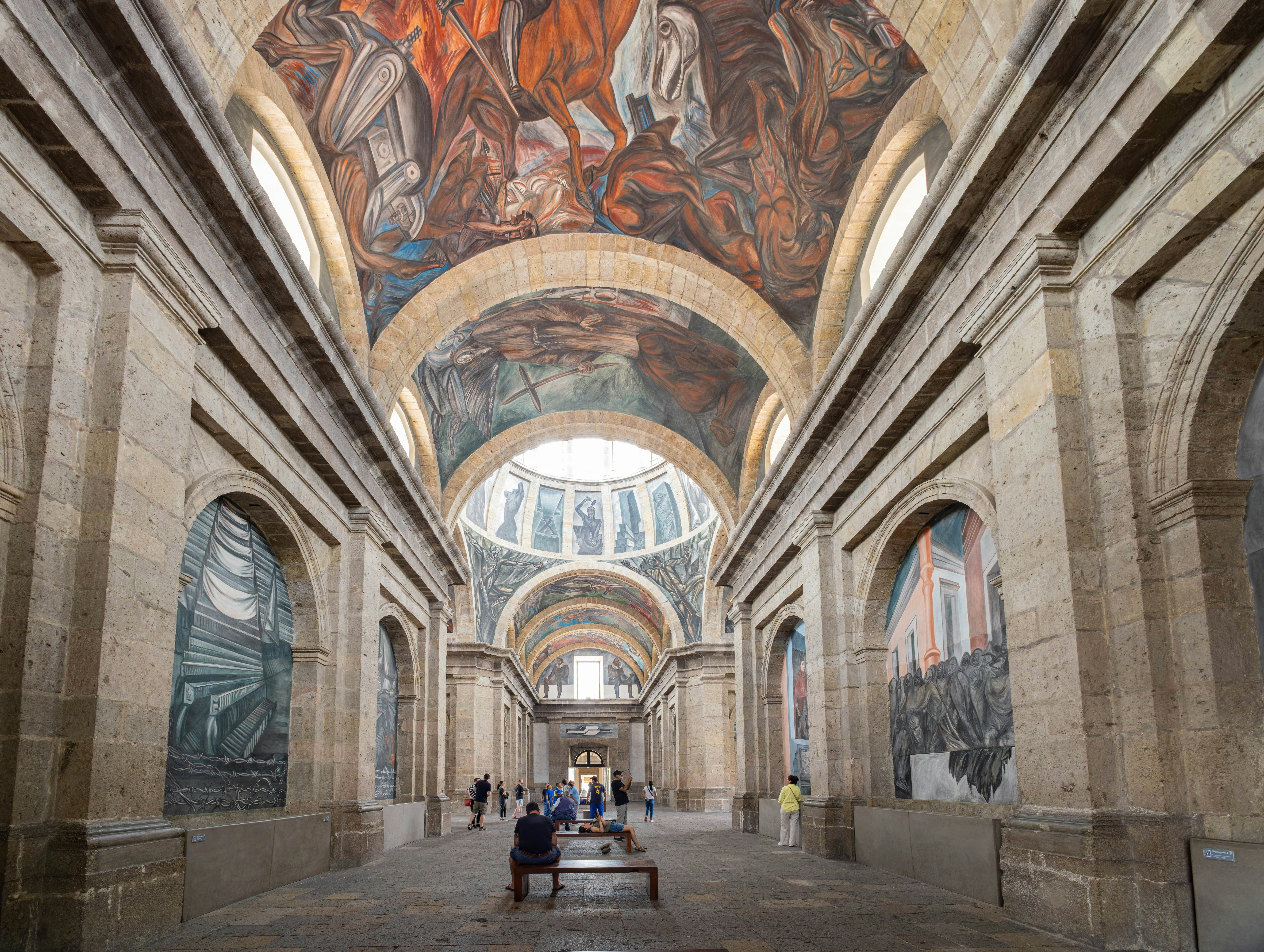 A large hall with murals displayed on the walls and ceilings.