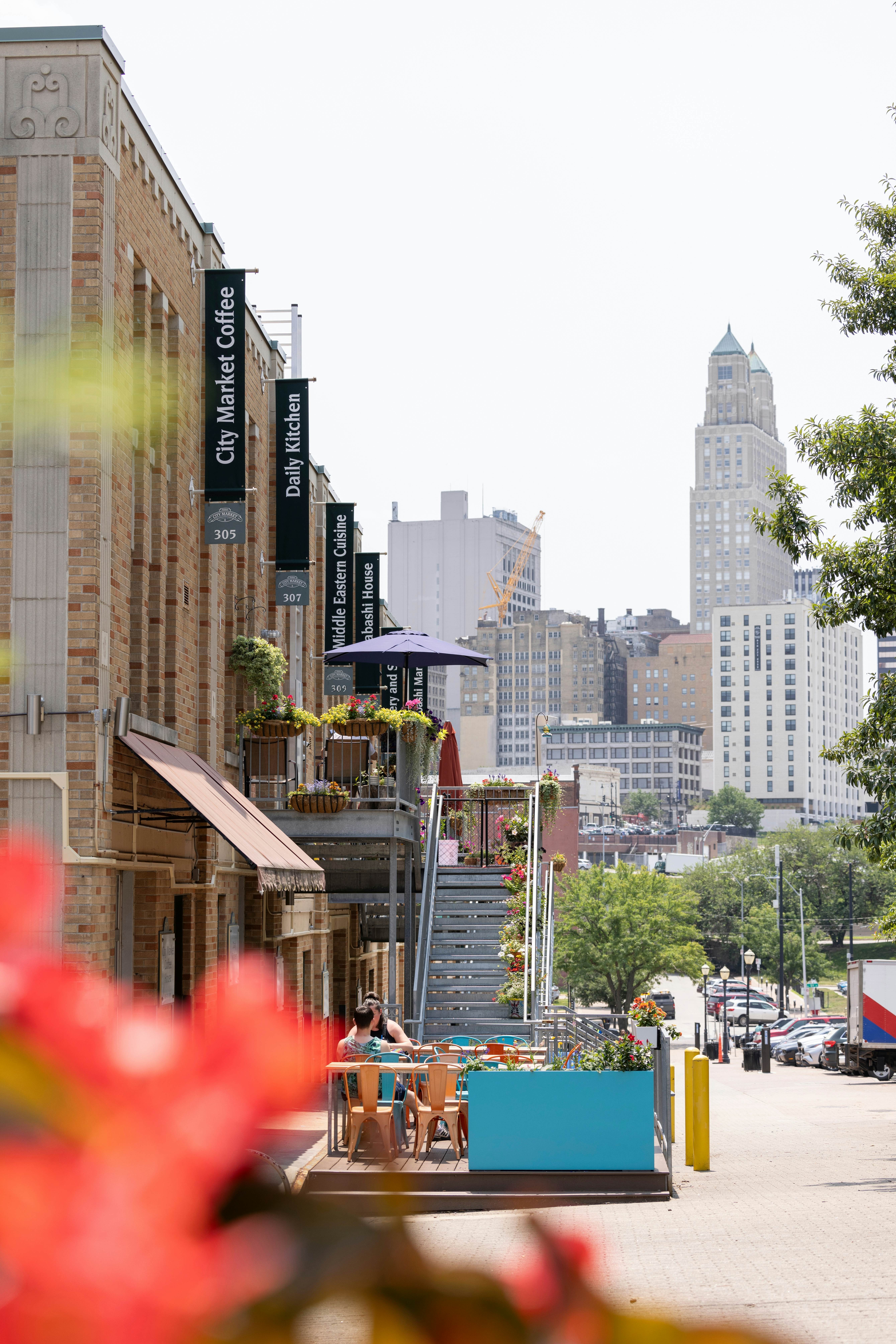 A city street with a high-rise skyline on a sunny day.