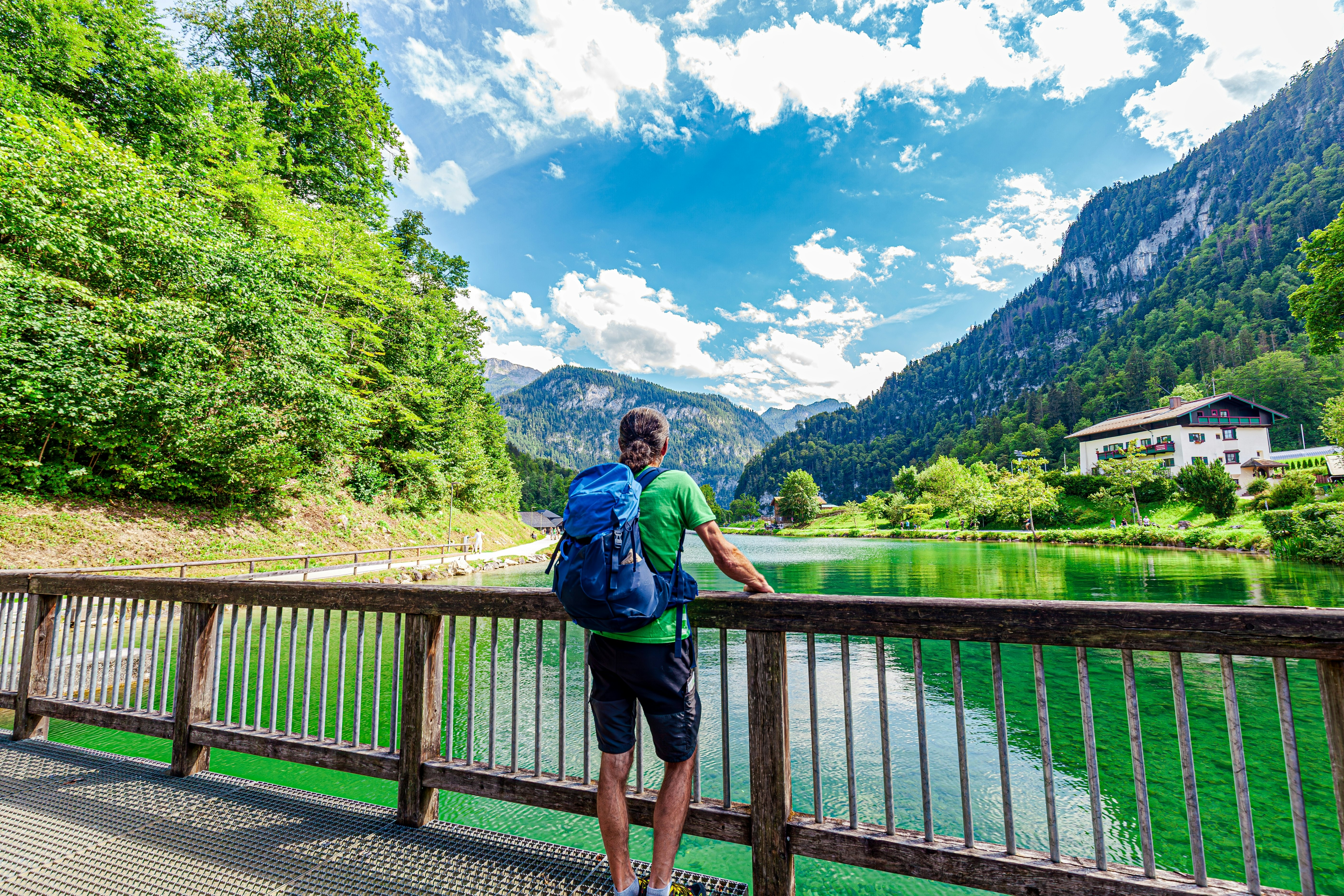 Hiker in the Alps. Backpacker tourist hiking at Lake Koenigssee, Berchtesgaden Alps, Bavaria, Schönau am Königssee, Germany