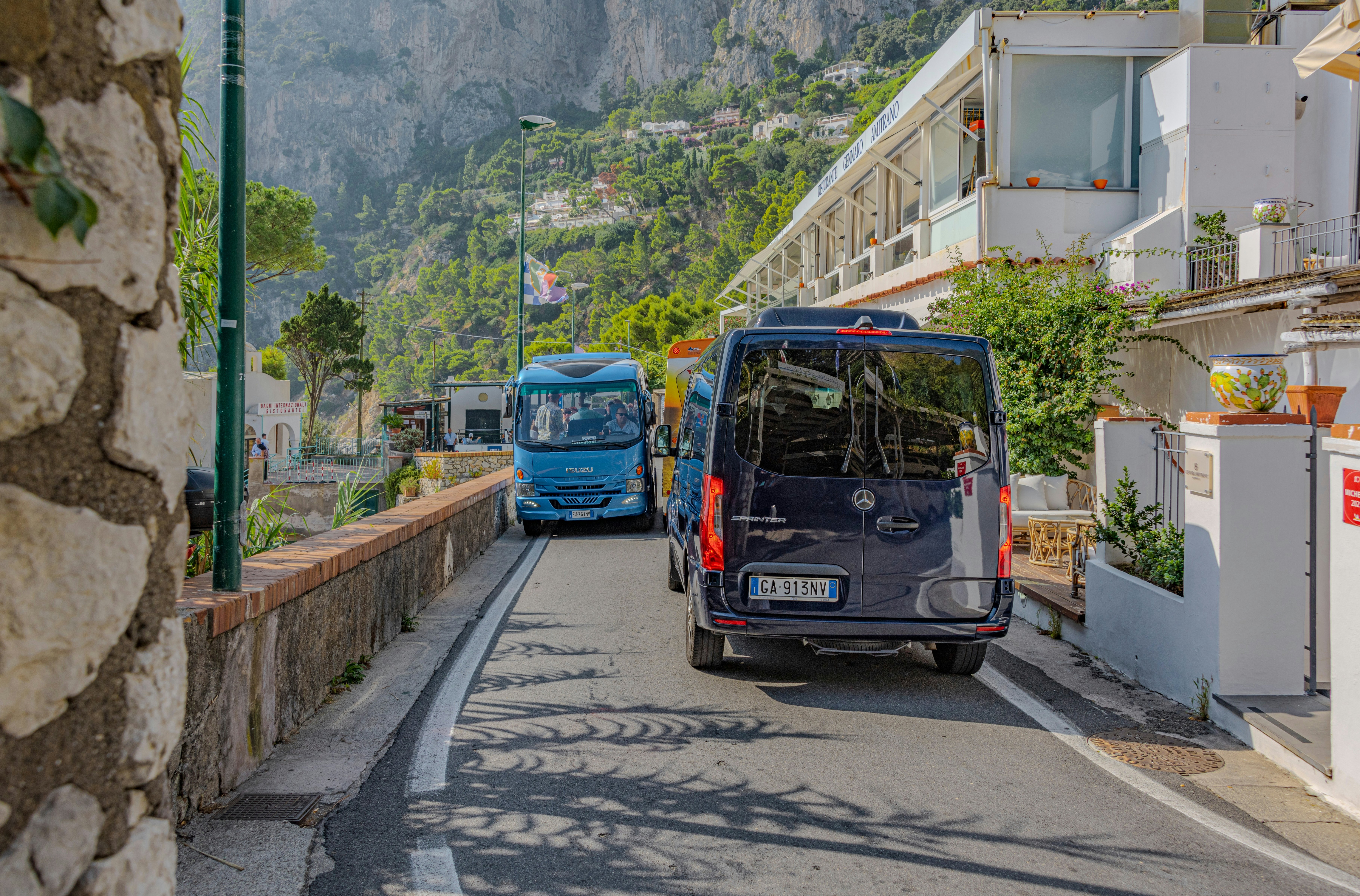 Marina Piccola, Capri, Campania, Italy -- Buses navigating the narrow roads on the Italian island of Capri
