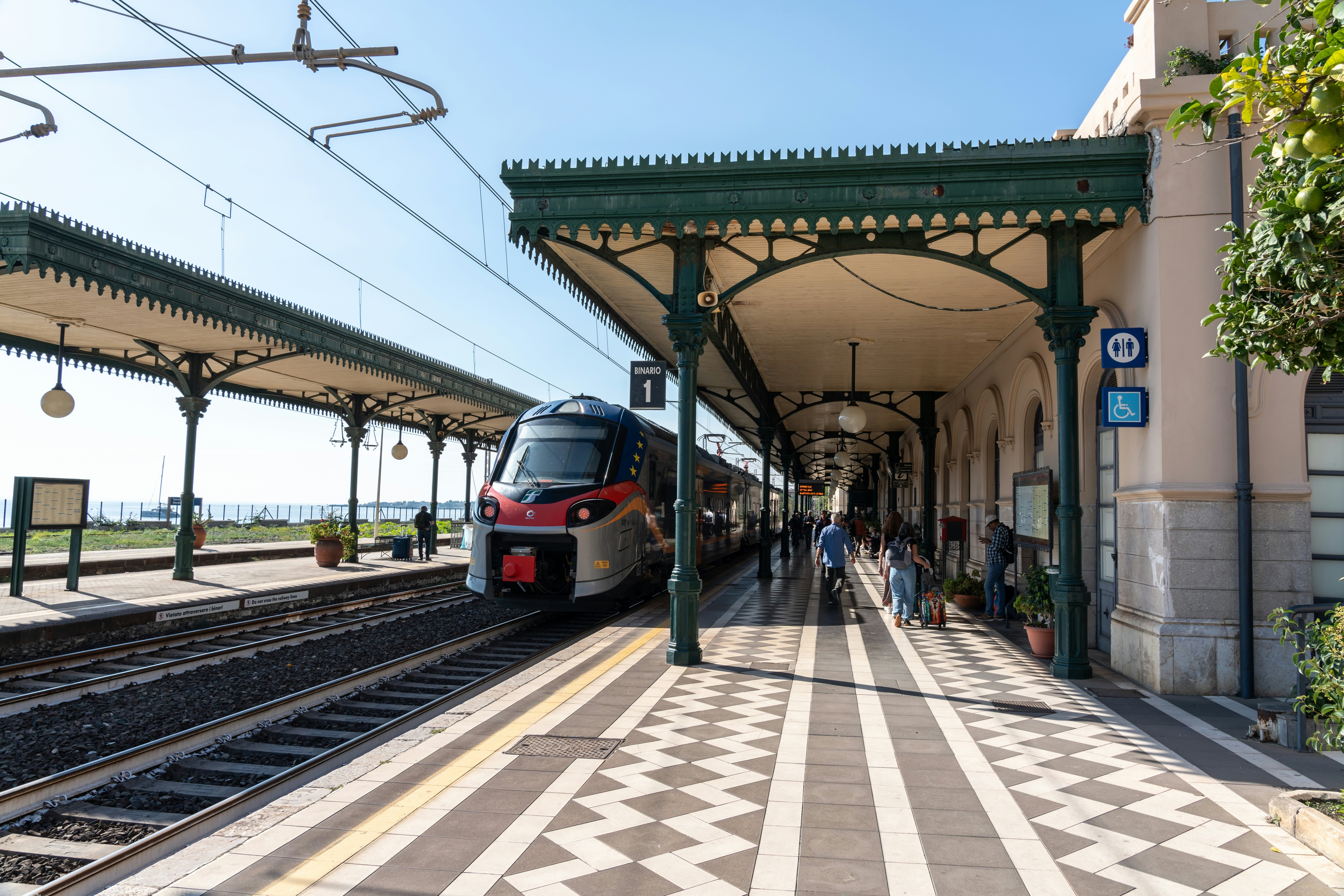 A passenger train rolls into Taormina, Sicily, Italy.