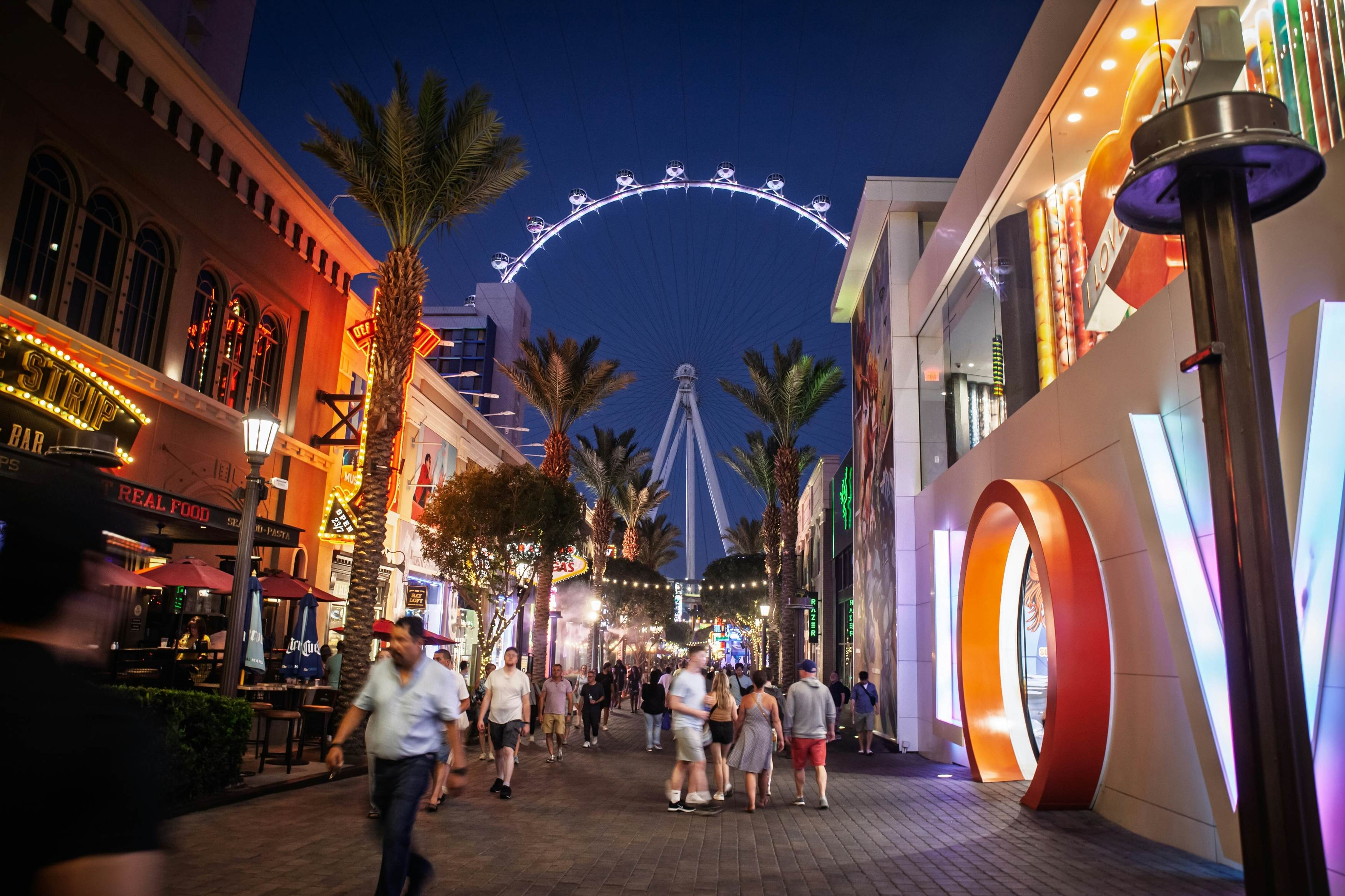 LAS VEGAS, AUGUST 21, 2024: night scene on the Linq Promenade, Las Vegas Strip. Walkway glows with neon as visitors stroll toward the lit High Roller wheel, showing the city's entertainment corridor.; Shutterstock ID 2630295997; purchase_order:65050 - Digital Destinations and Articles; job:Lonely Planet Online Editorial; client:When to visit Las Vegas; other:Brian Healy
2630295997
