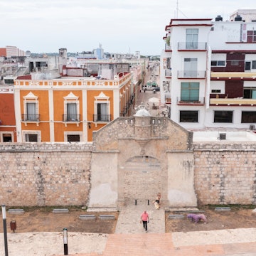Campeche, Campeche, Mexico - June 14, 2024: People walk through the historic gate of the colonial walls of the central district., License Type: media, Download Time: 2026-02-24T15:39:39.000Z, User: clairenaylor, Editorial: true, purchase_order: 65050 - Digital Destinations and Articles, job: Online editorial, client: Historic sites Mexico, other: Claire Naylor