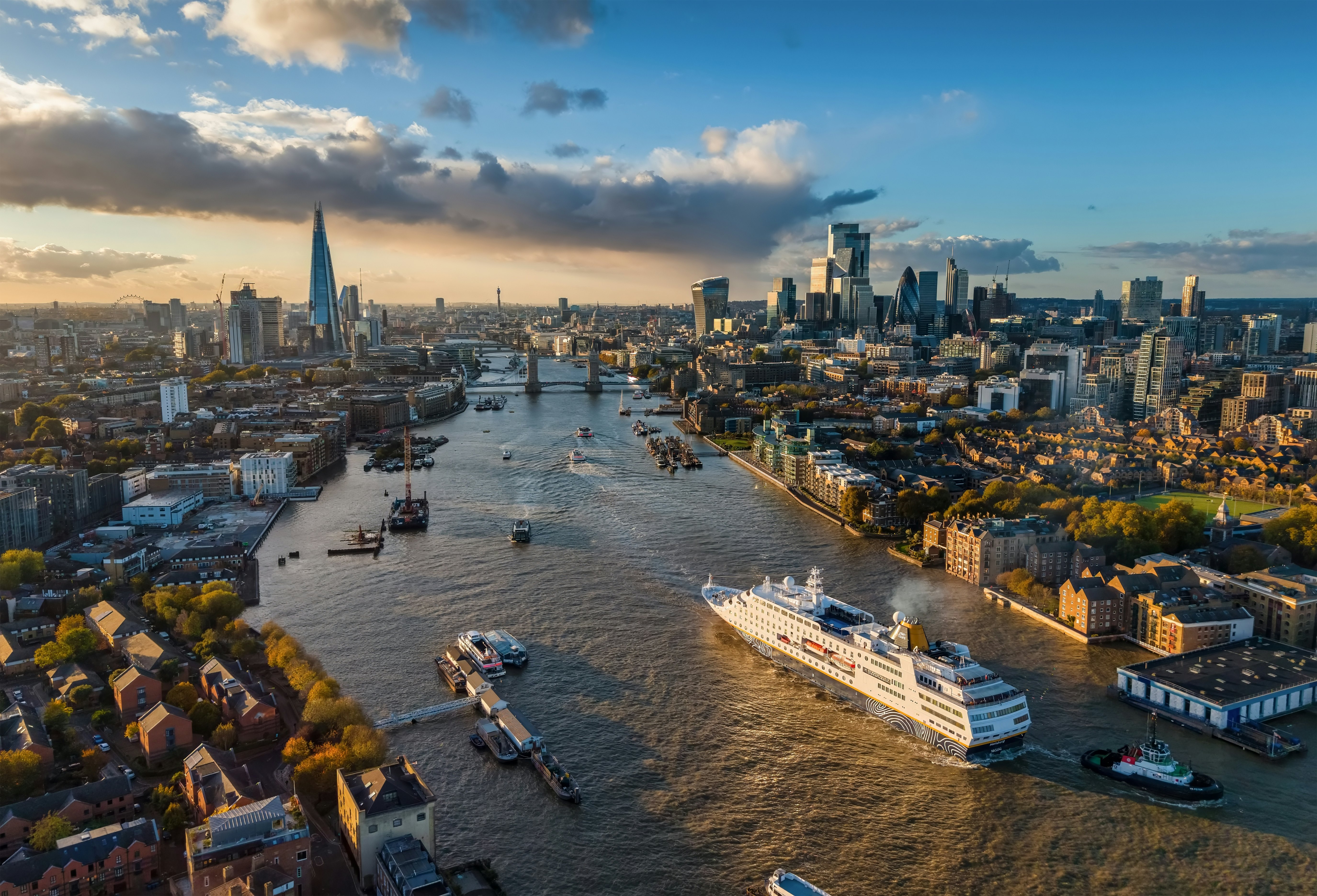 London, England - October 25th 2025: aerial view of the cruise ship MS Hamburg traveling over the Thames river towards Tower Bridge