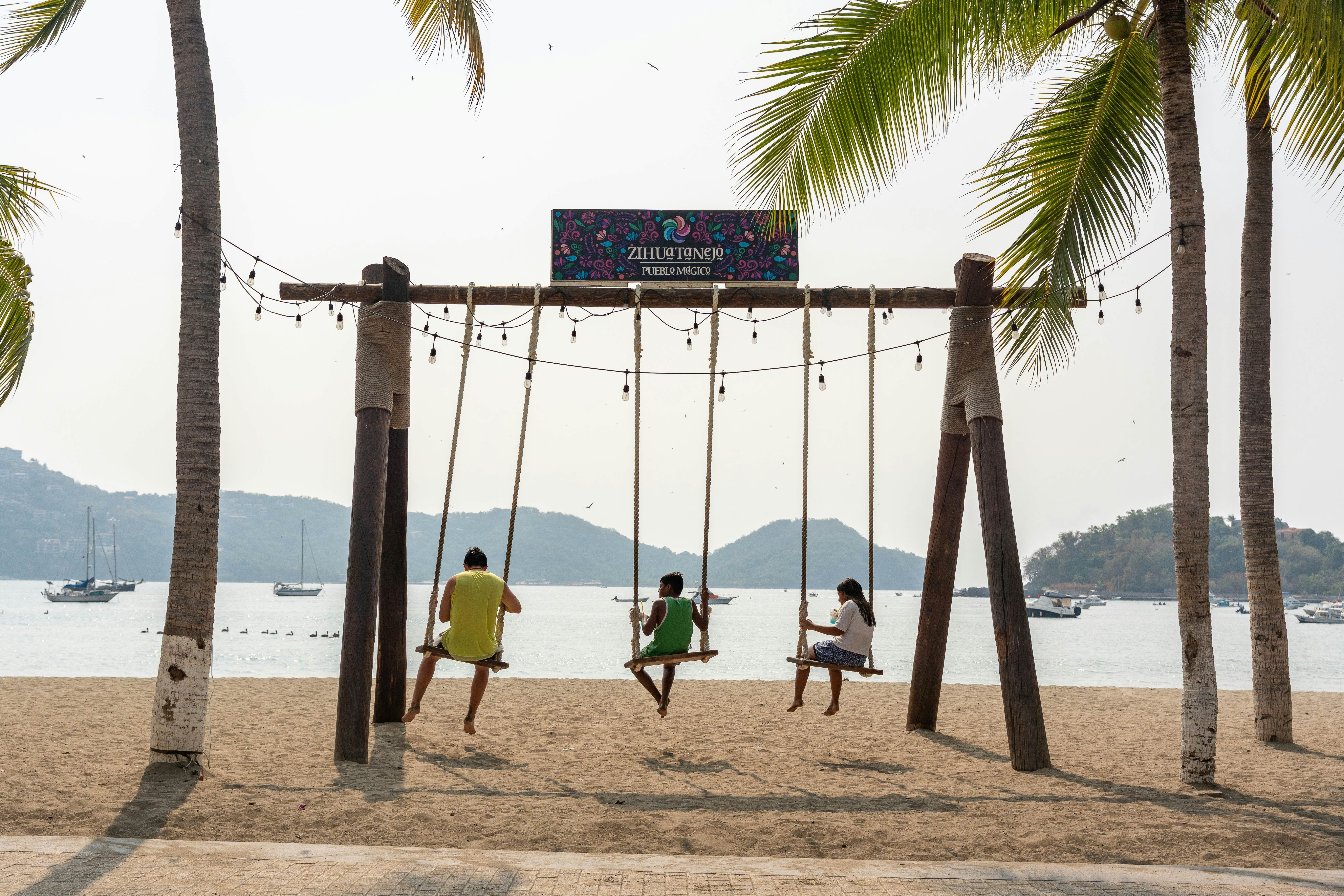 Swings with a panoramic view of Ixtapa Zihuatanejo bay at the Paseo del Pescador Boardwalk, Costa Grande, Guerrero. Tourist attraction facing the sea. Mexico, January 19, 2026, License Type: media, Download Time: 2026-02-20T18:34:50.000Z, User: bhealy950, Editorial: true, purchase_order: 65050 - Digital Destinations and Articles, job: Lonely Planet Online Editorial, client: Guide to Zihuatanejo, other: Brian Healy