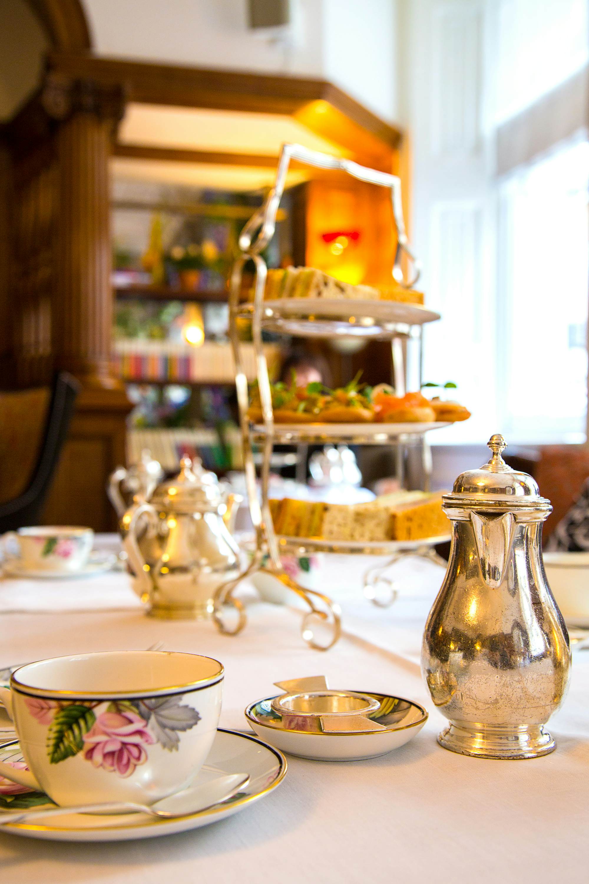 Table with different snacks and sandwiches during afternoon tea ceremony in London