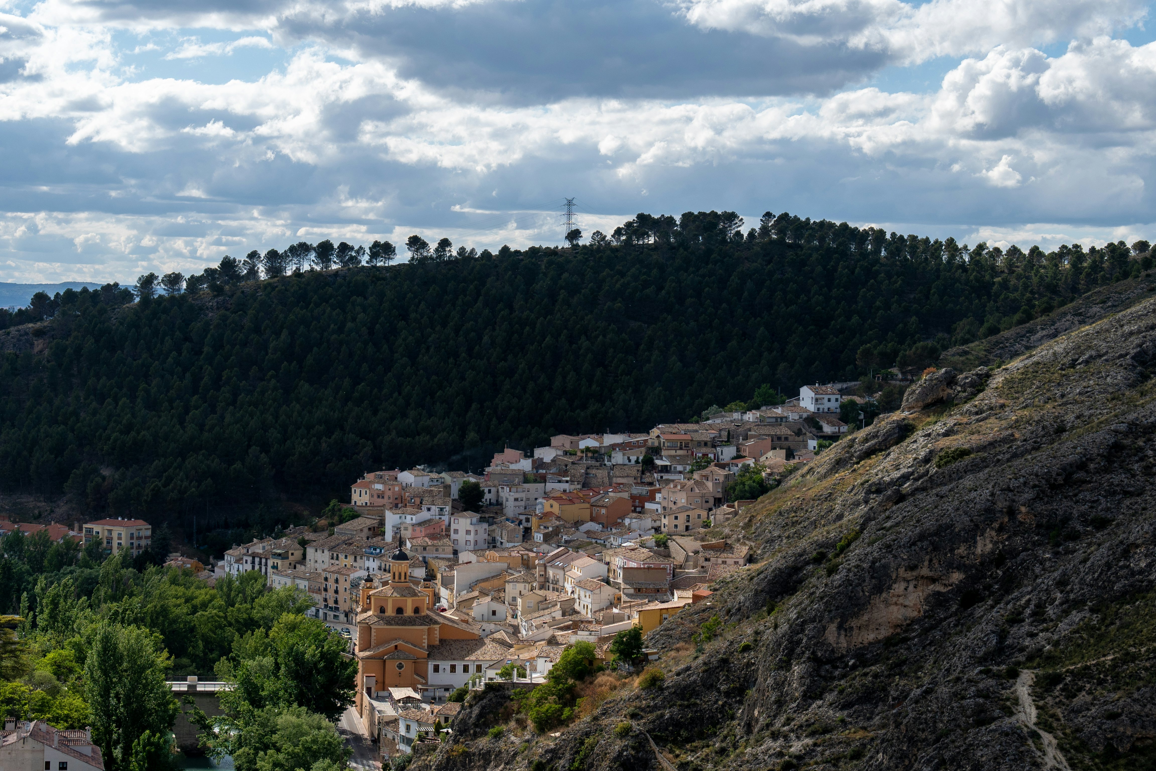 A town built into the hillside of a ravine where two hills meet.