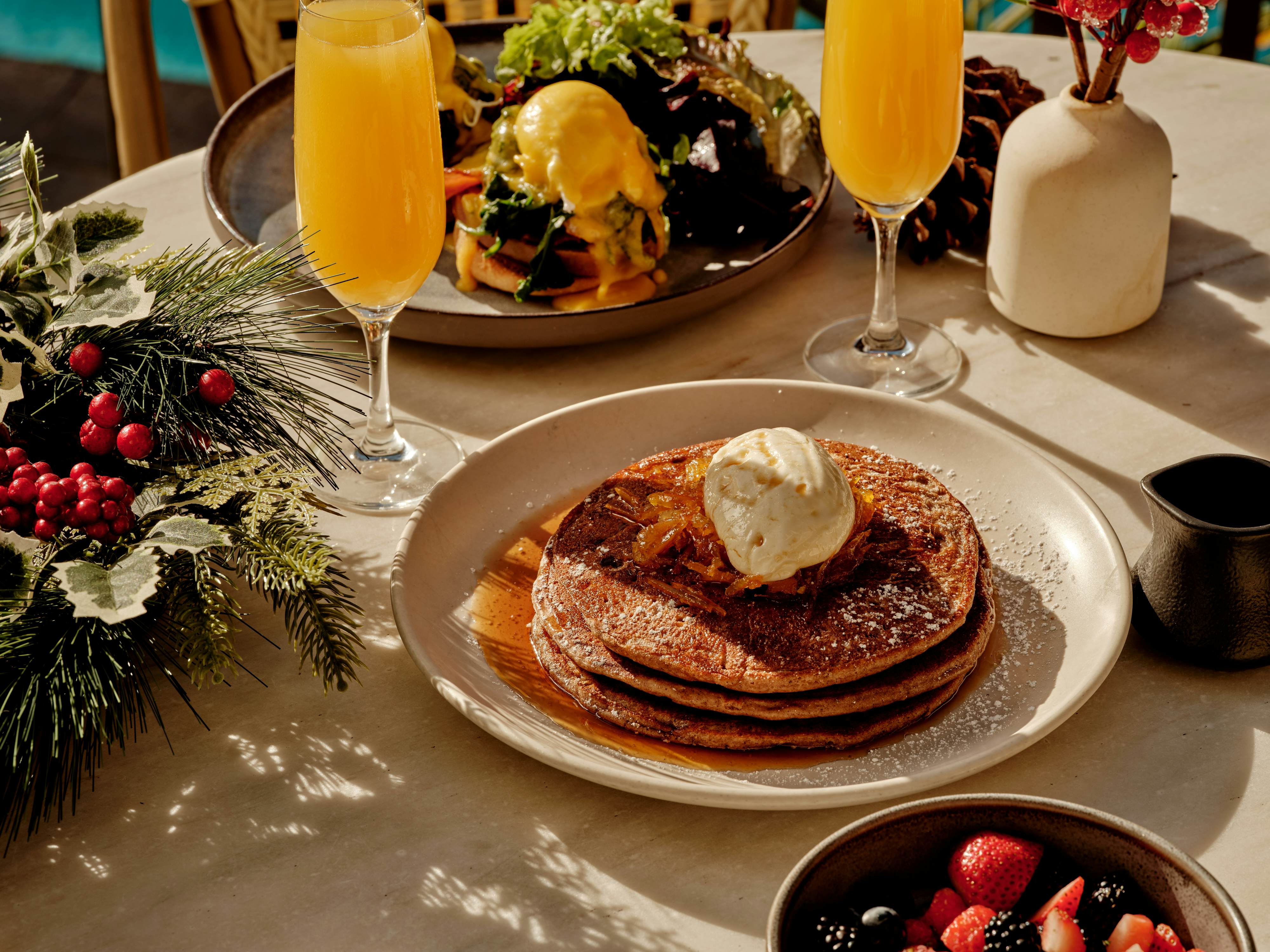 A plate of pancakes and a mimosa. 