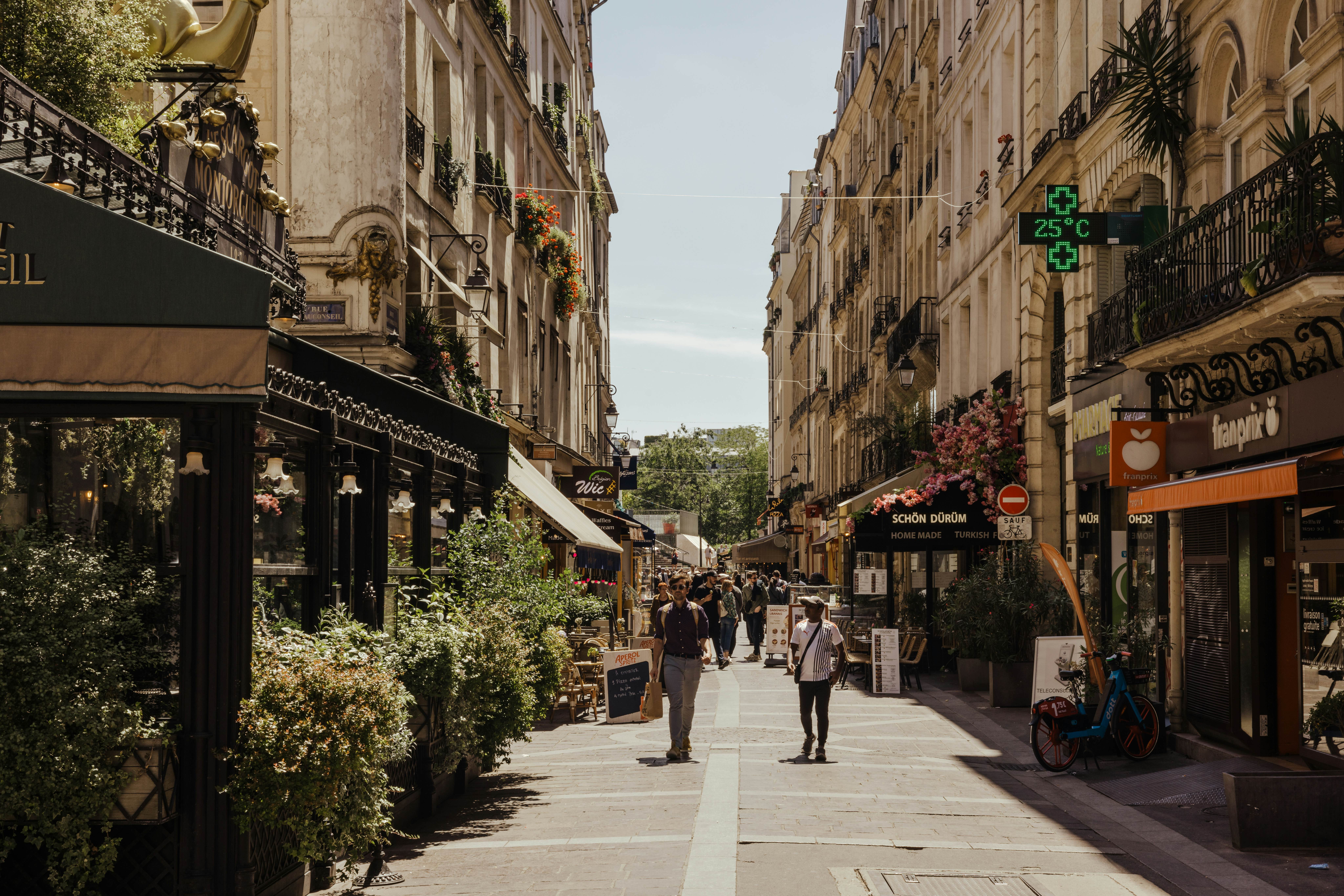 Street scene on Rue Montorgueil, which stretches from the 1st to the 2nd Arrondissement in Paris, France.
Paris, France, June 2024. 
Kate Devine for Lonely Planet