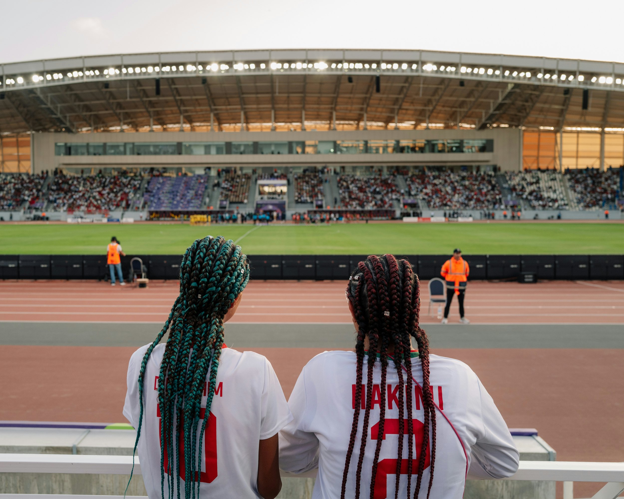 Two young girls enter the stadium for the match between Morocco and Nigeria at the 2024 Women’s Africa Cup of Nations.