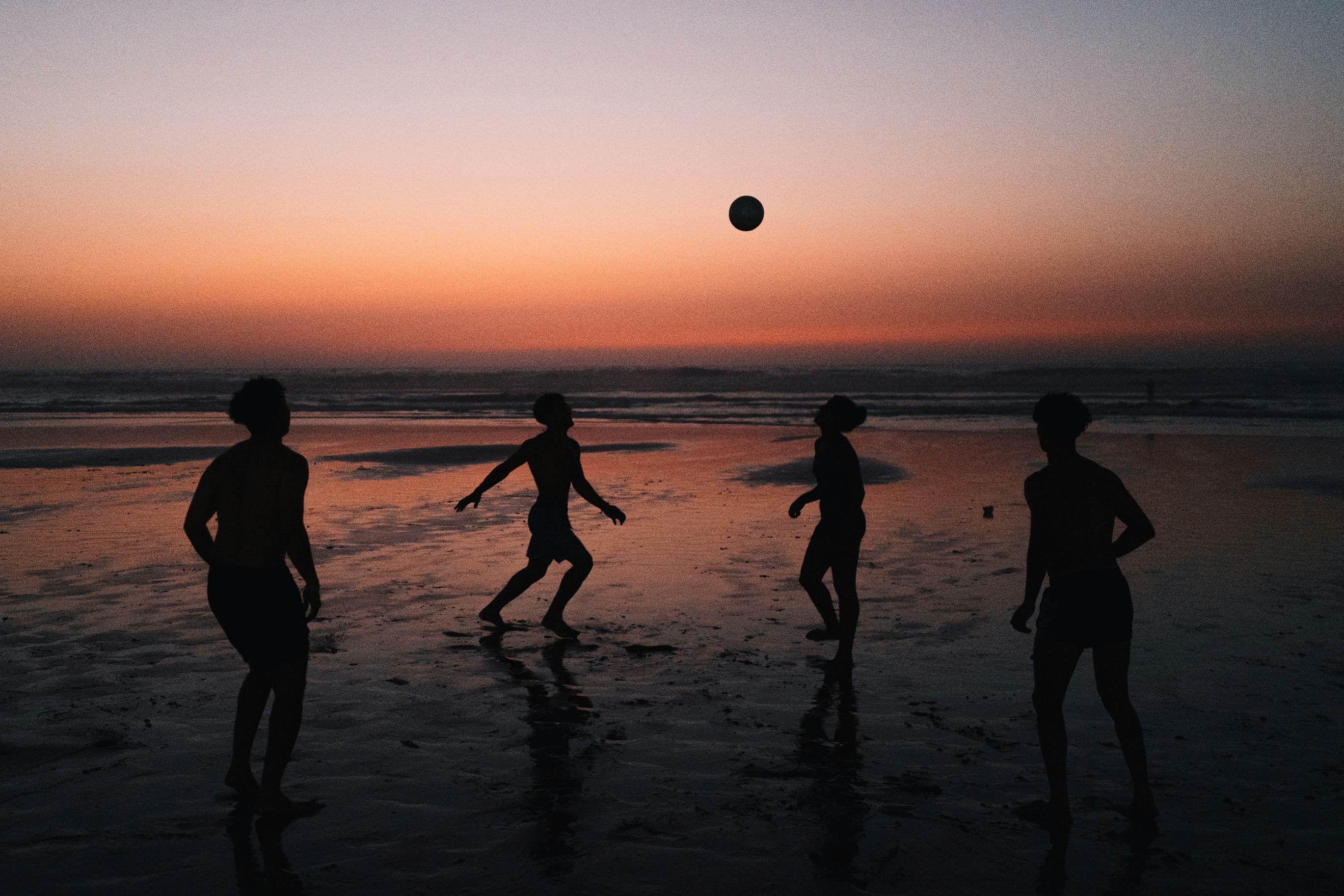 Young men juggle a soccer ball at a Casablanca beach.
For World Cup photo essay