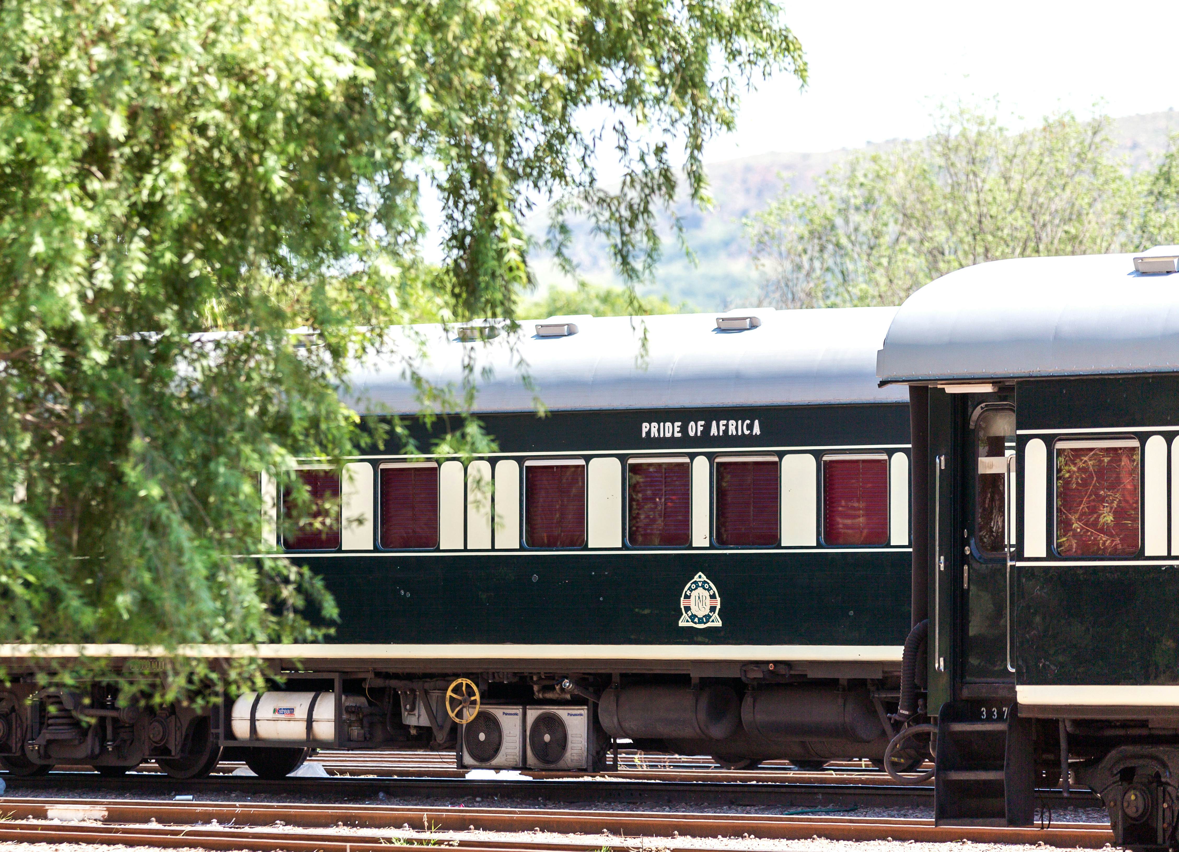 The exterior of a train carriage with the words "Pride of Africa" printed above the windows.