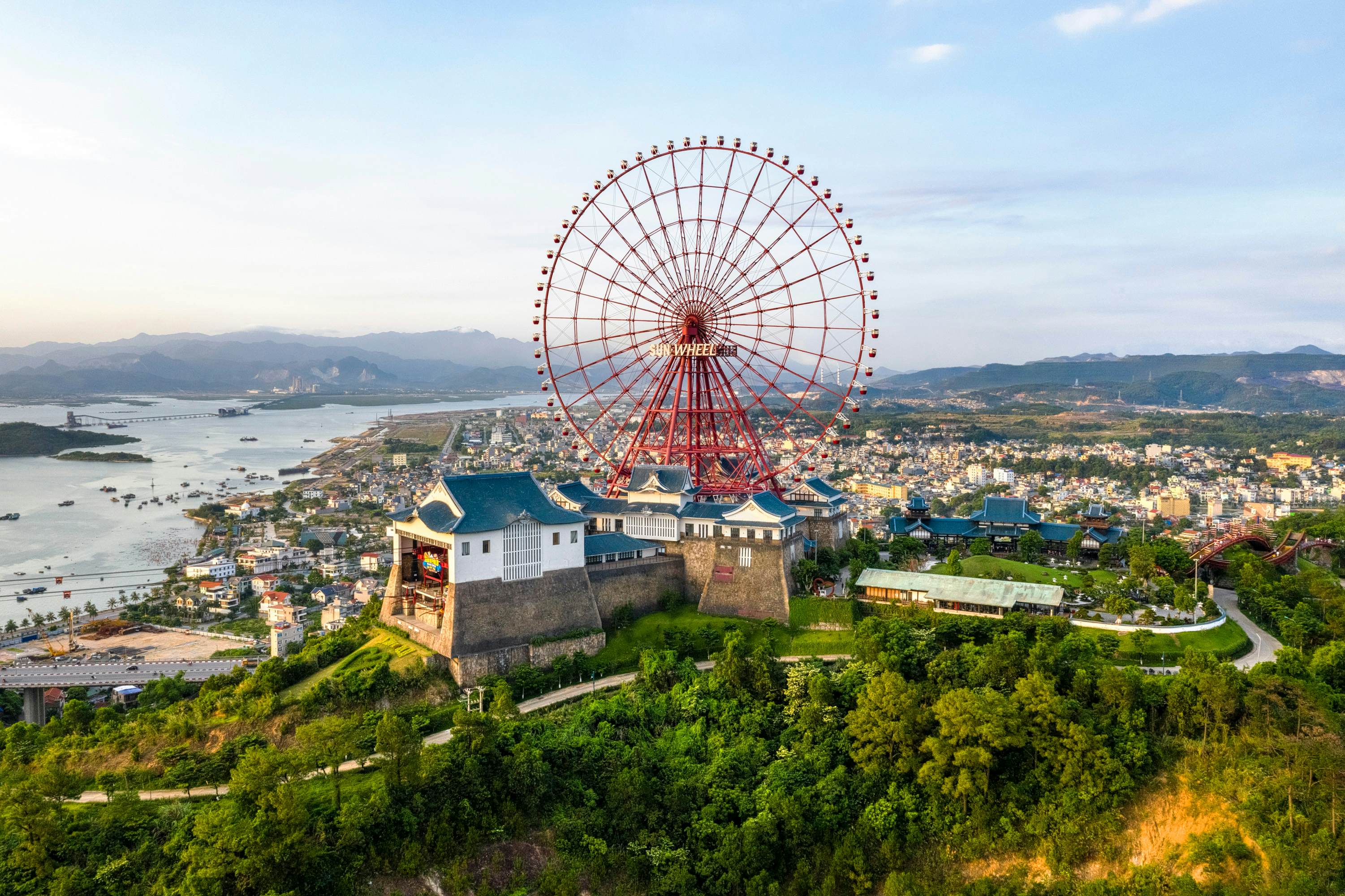 QUANG NINH, VIET NAM - FEB 12, 2019: Aerial view of Sun World Halong park, with Sun Wheels and underwater games. Halong City, Vietnam. Near Halong Bay, UNESCO World Heritage Site.   License Type: media  Download Time: 2022-03-22T18:23:25.000Z  User: lonelyplanetmedia  Is Editorial: Yes  purchase_order:   
