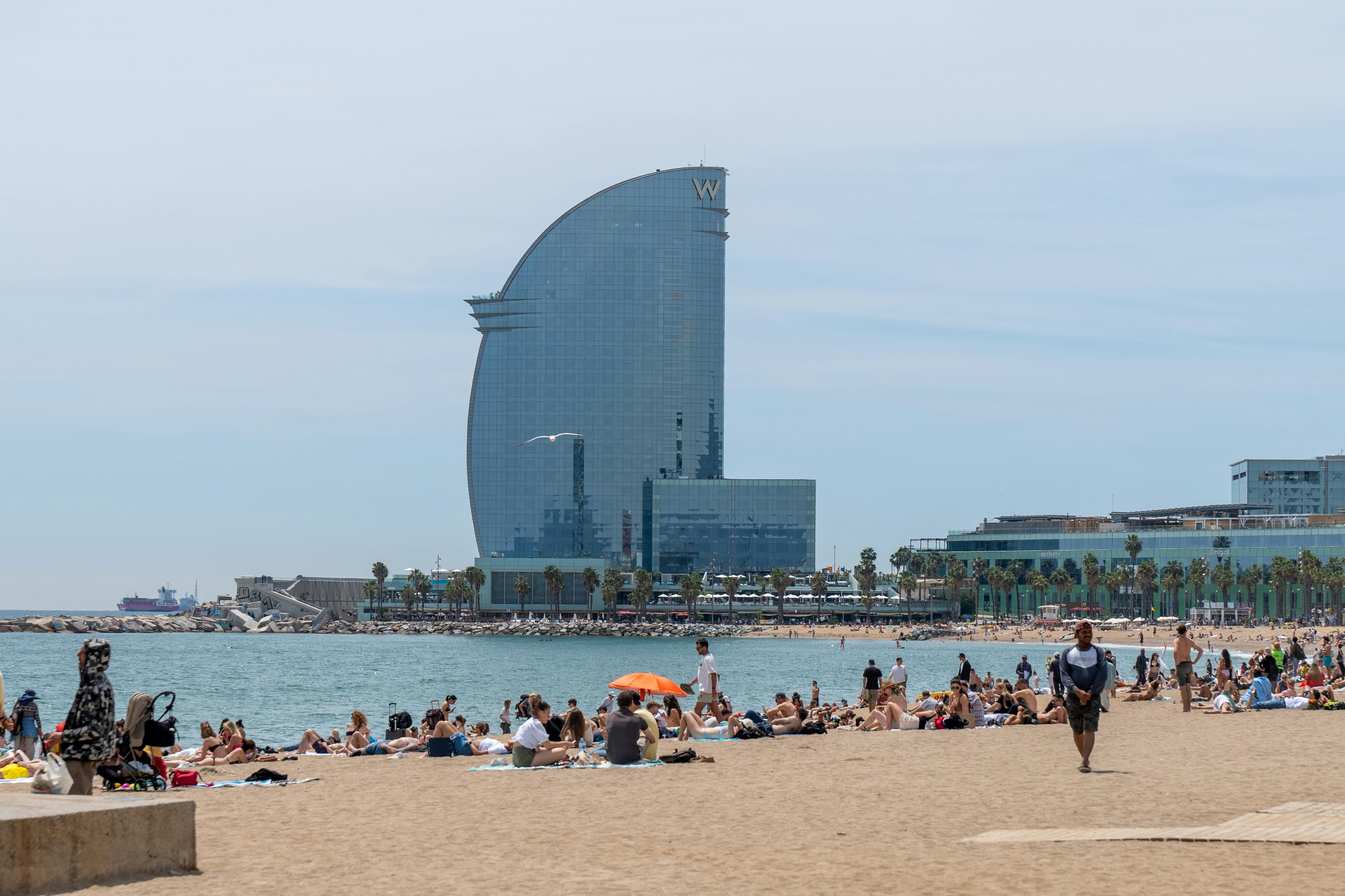 The sail-shaped W Hotel rises above Platja de Sant Sebastià