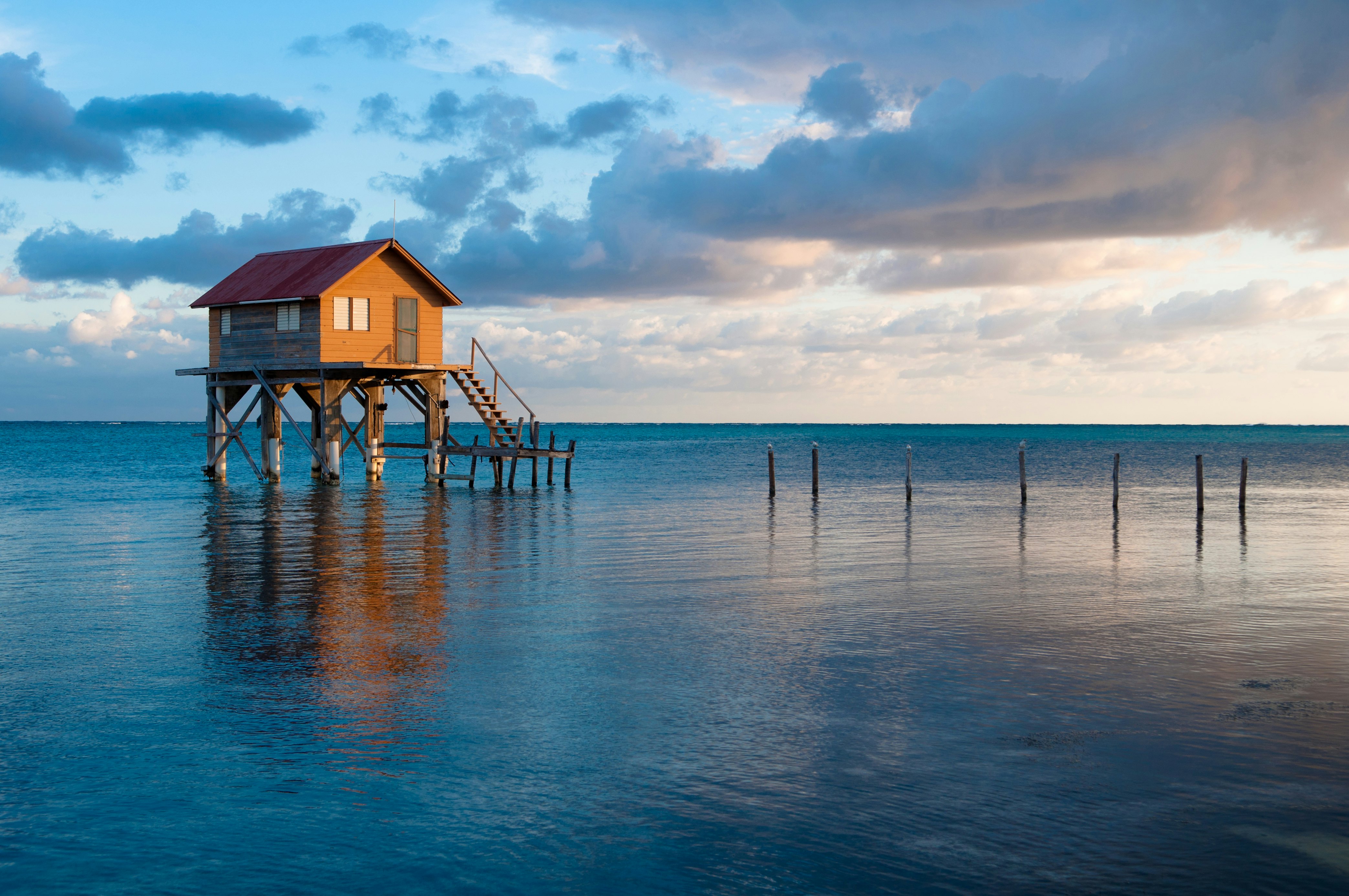 A structure on stilts in the blue sea.