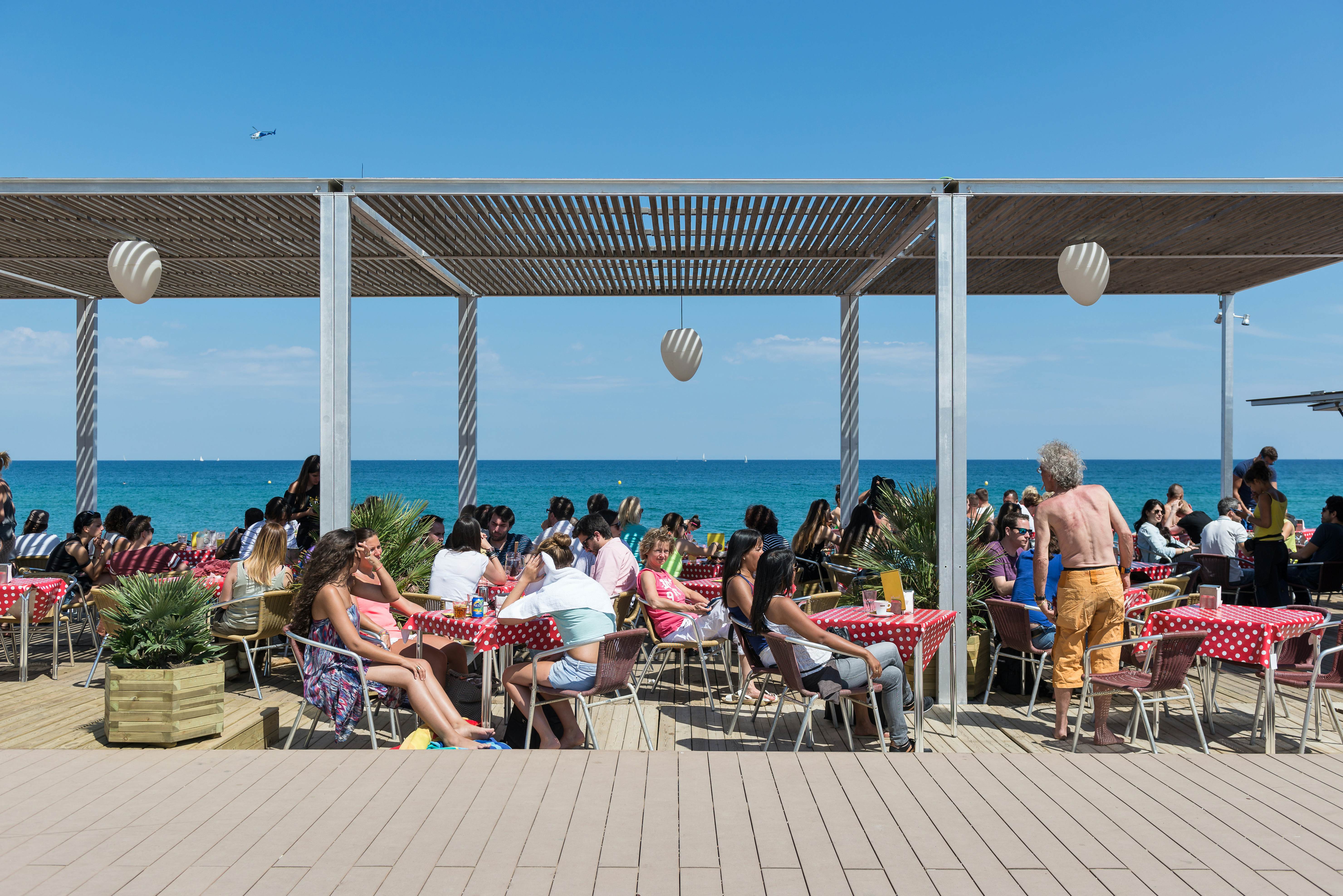 BARCELONA, SPAIN - JUNE1, 2014: People enjoying a Barceloneta Beach Bar in summer time. Barceloneta Beach is one of the most popular beach in the city.
bar, barcelona, barceloneta, beach, blue, building, catalonia, city, cityscape, coast, cocktail, destination, drink, europe, european, food, holiday, hotel, landmark, lunch, mediterranean, people, sail, sand, sea, sky, spain, summer, sunbathe, sunny, tourism, tourist, travel, urban, vacation, view, w, water