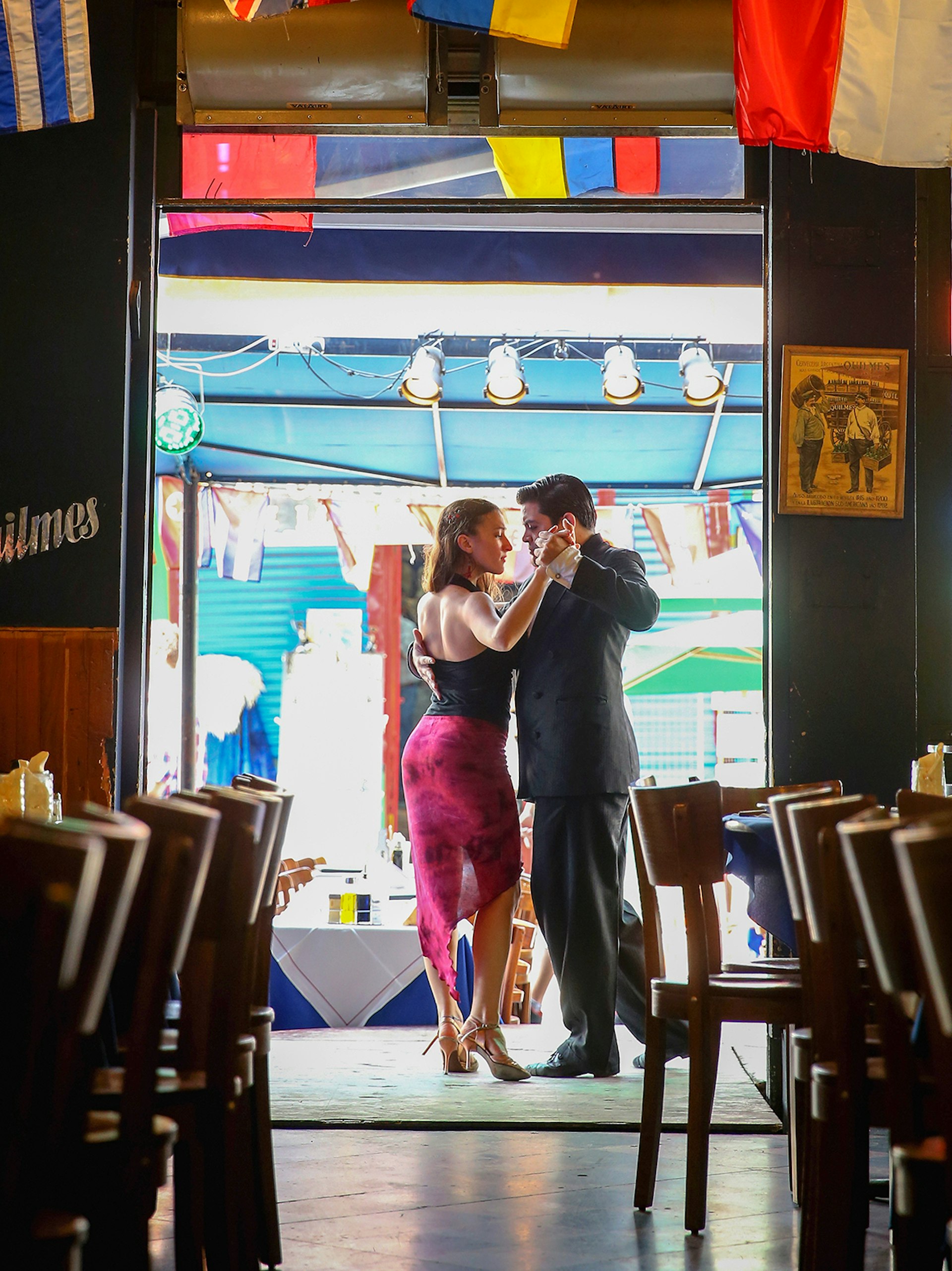 Two people dance in a doorway at La Boca in Buenos Aires, Argentina