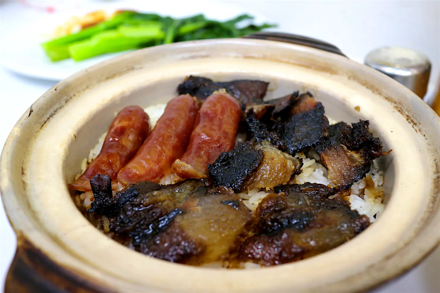 Features - Claypot rice with Chinese sausages and cured pork. Image by Piera Chen / Lonely Planet Claypot rice with Chinese sausages and cured pork. Image by Piera Chen / Lonely Planet