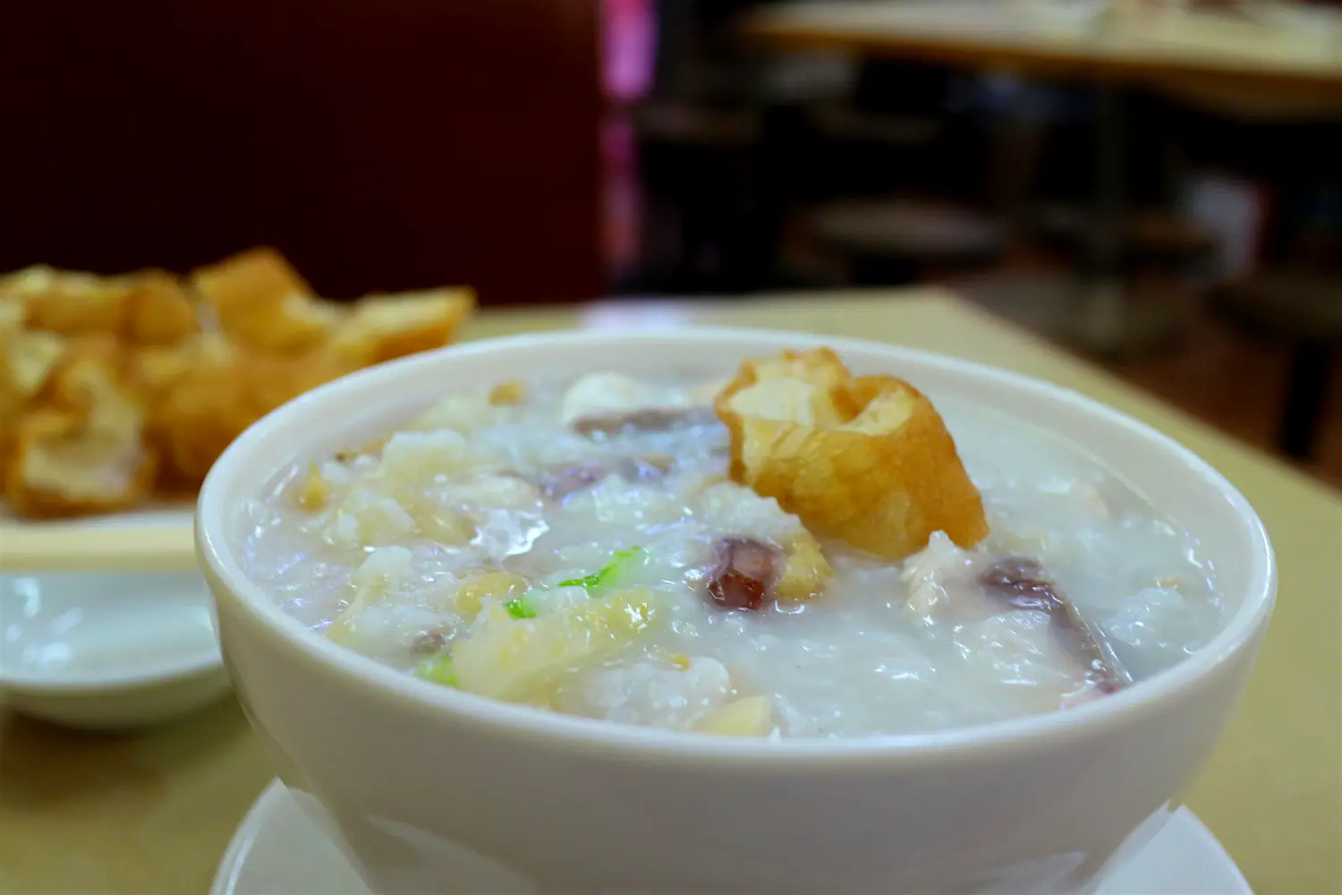 Features - 'Fisherfolk' congee with seafood and peanuts, and a side of Chinese crullers. Image by Piera Chen / Lonely Planet 'Fisherfolk' congee with seafood and peanuts, and a side of Chinese crullers. Image by Piera Chen / Lonely Planet