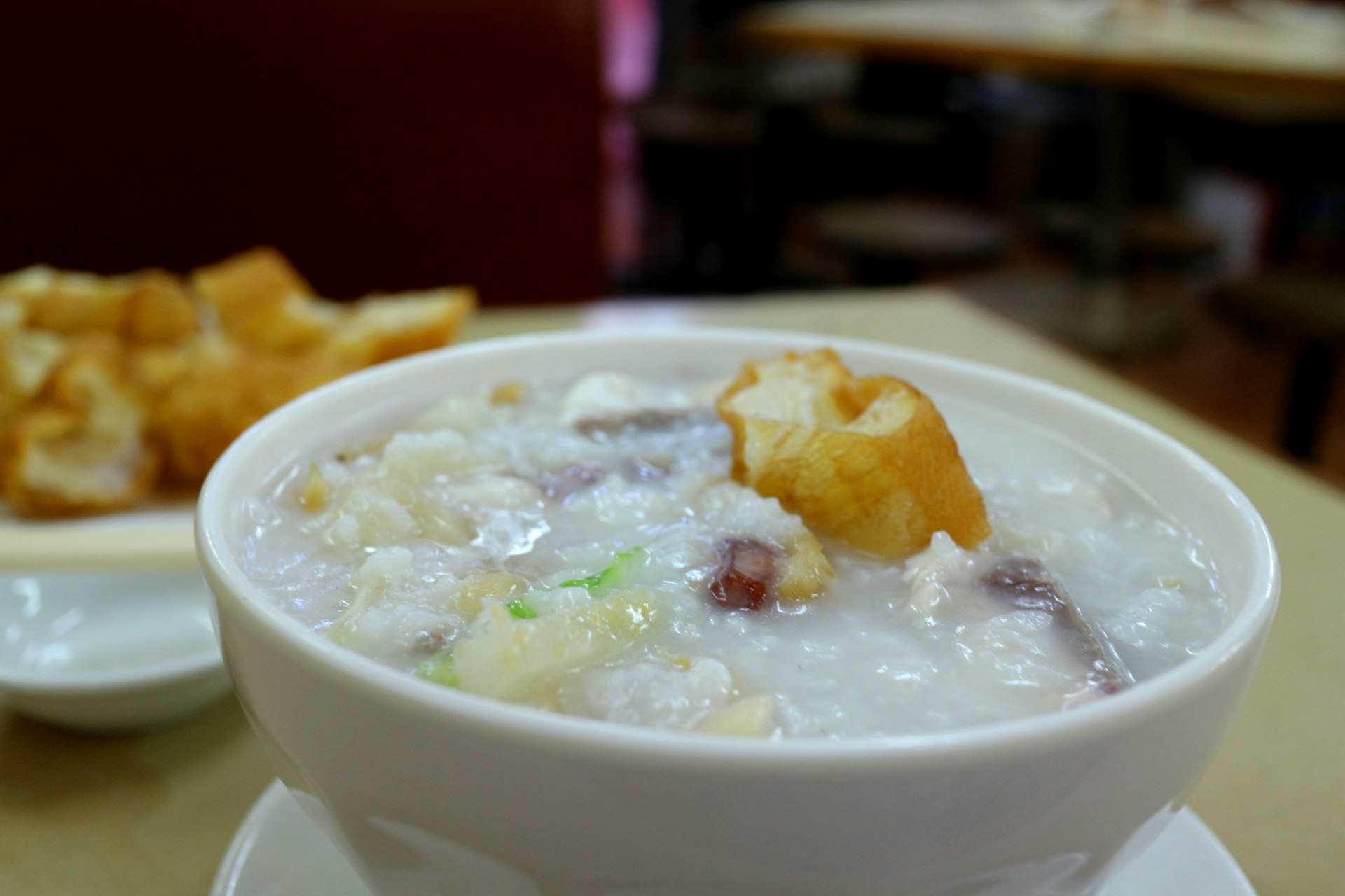 'Fisherfolk' congee with seafood and peanuts, and a side of Chinese crullers. Image by Piera Chen / Lonely Planet