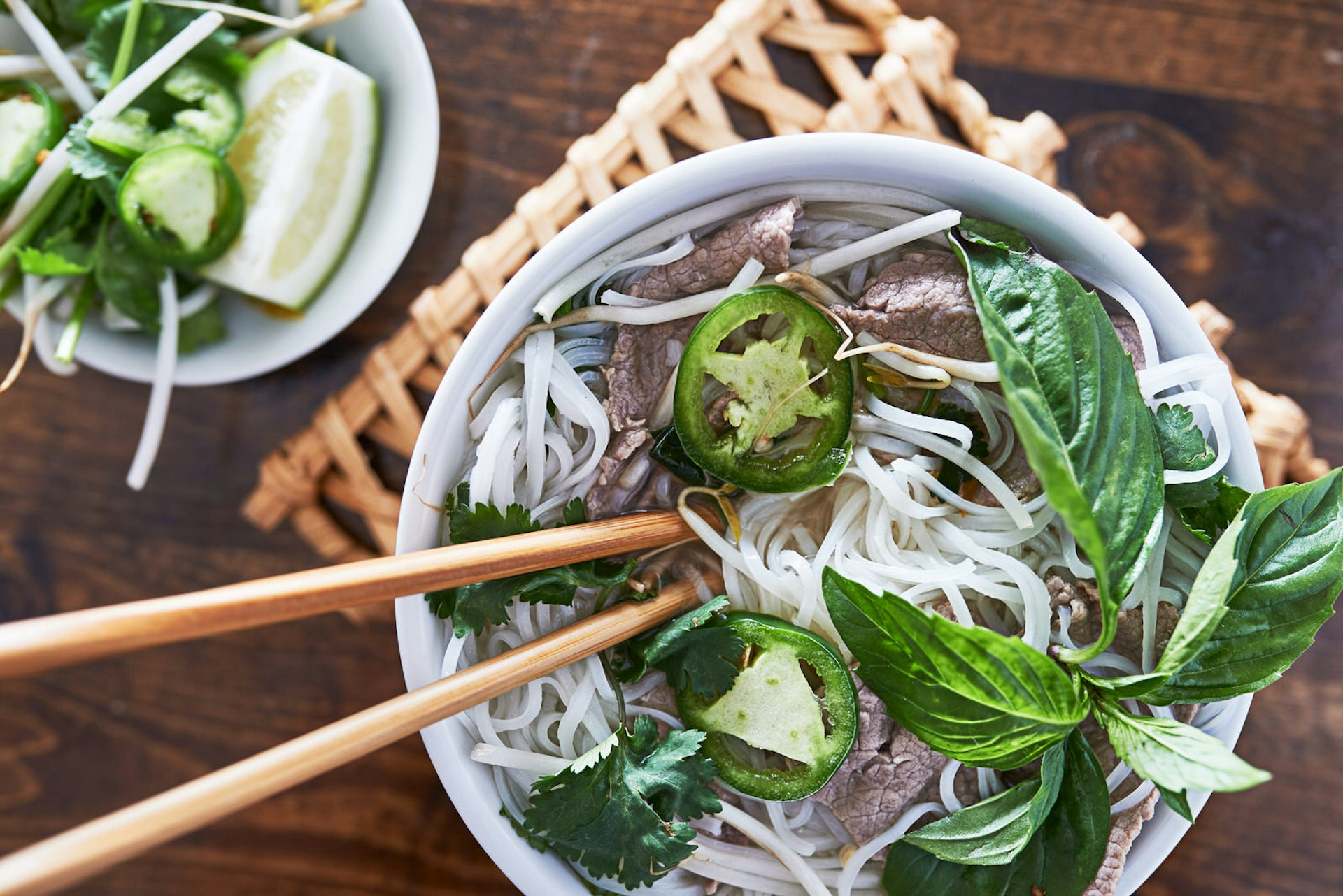 Overhead shot of a bowl of pho (beef rice noodle soup) © Joshua Resnick / Shutterstock 