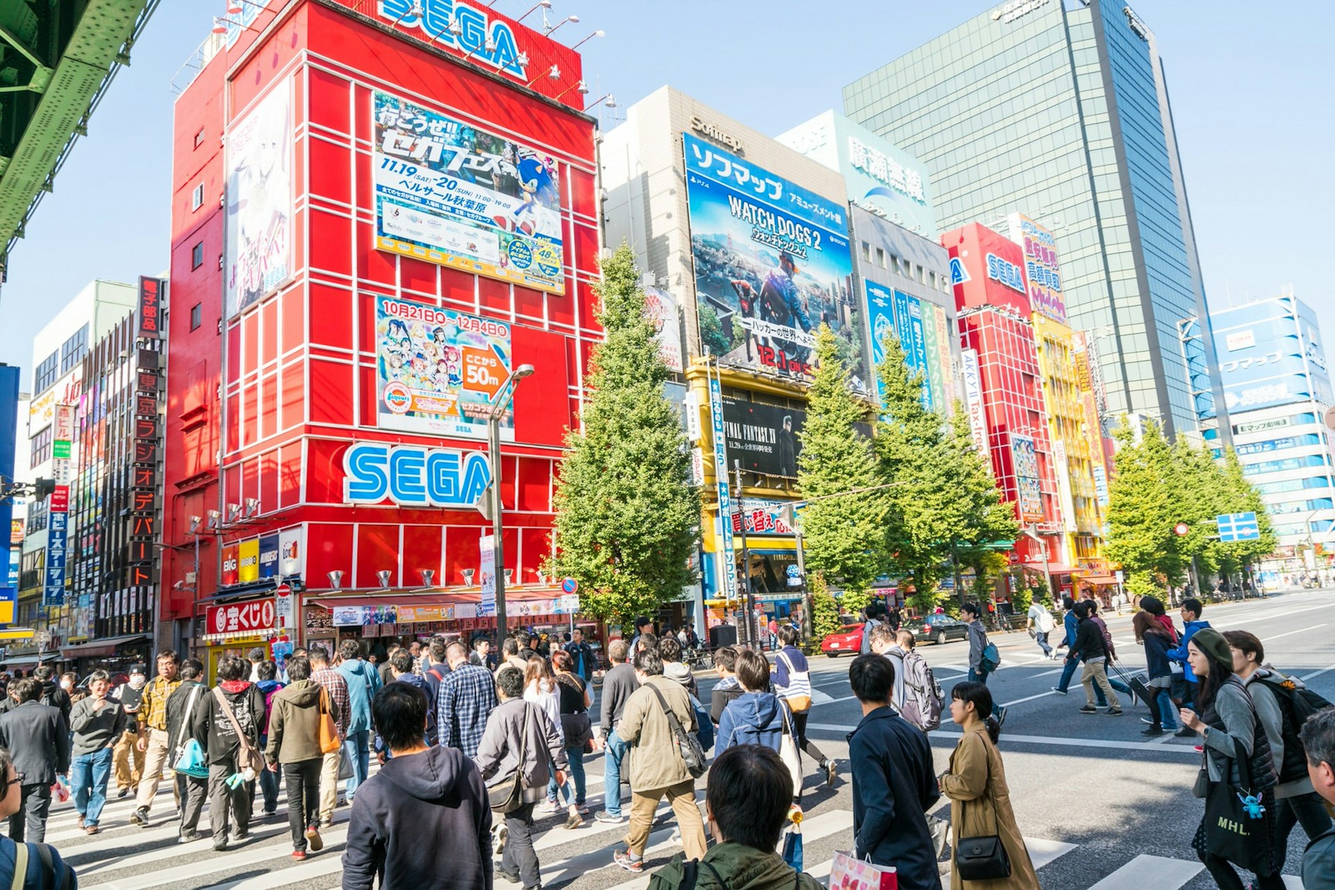 A busy daytime street in Akihabara, lined with large stores showing signs for games, anime and manga © Blue Planet Studio / Shutterstock