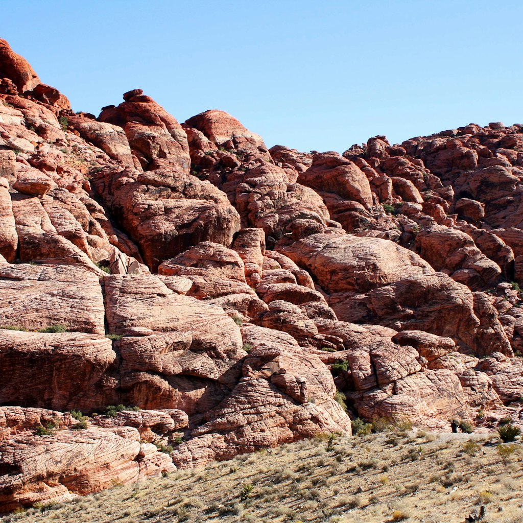 Hikers plan their route near rock formations in Red Rock Canyon. Image by Alexander Howard / Lonely Planet