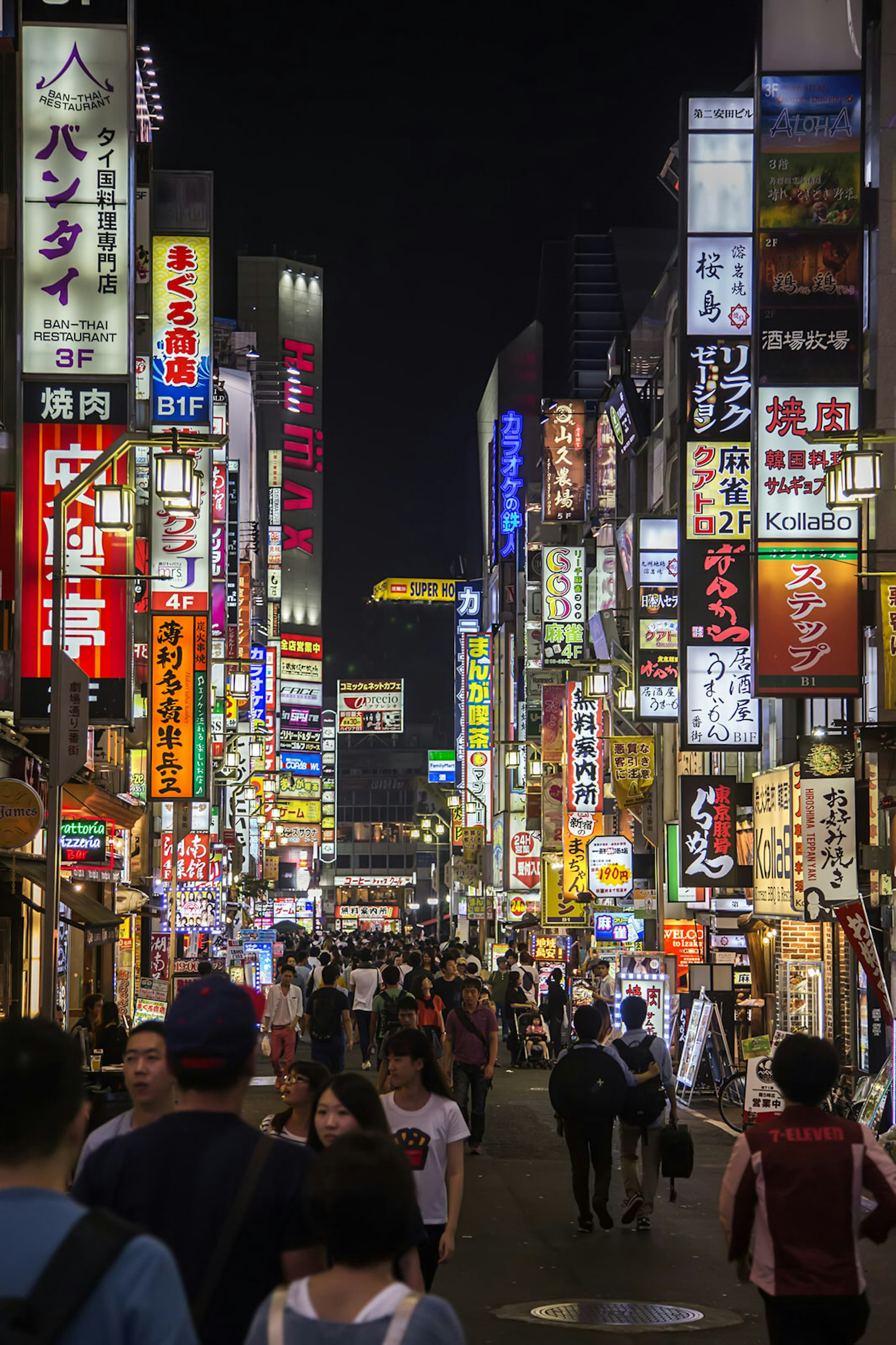 Countless bright lights and signs line the tall buildings along a narrow street in Shibuya, Tokyo © Goran Bogicevic / Shutterstock
