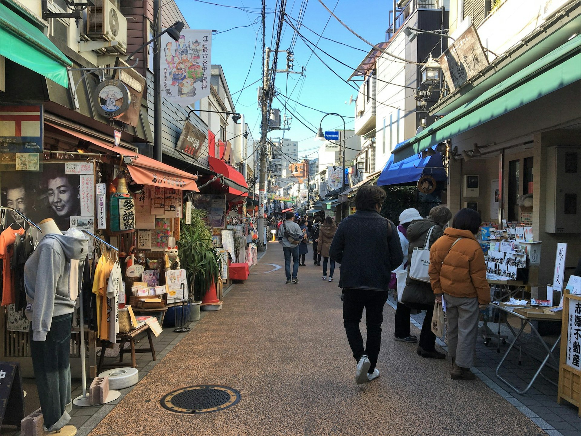 A narrow shopping street in Yanaka, where small independent stores have their wares displayed outside © Rebecca Milner / Lonely Planet