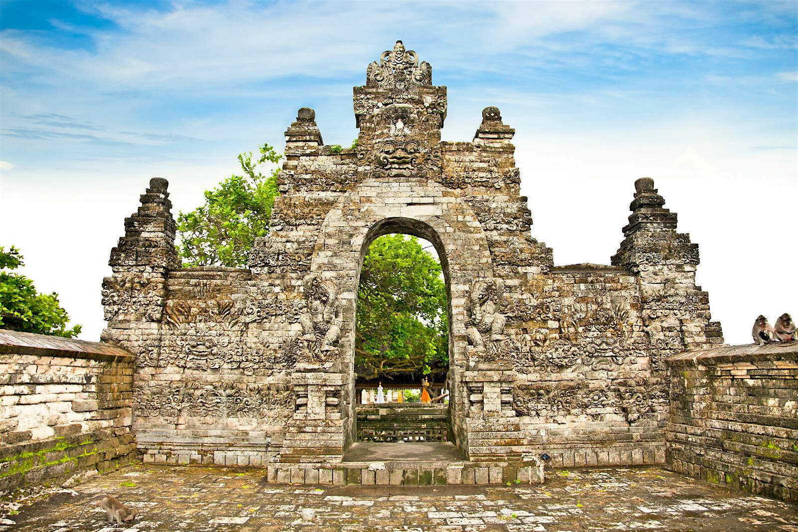 Features - Gate in Pura Luhur Uluwatu temple on Bali View of an old stone temple gate at Pura Luhur Ulu Watu © master2 / Getty Images