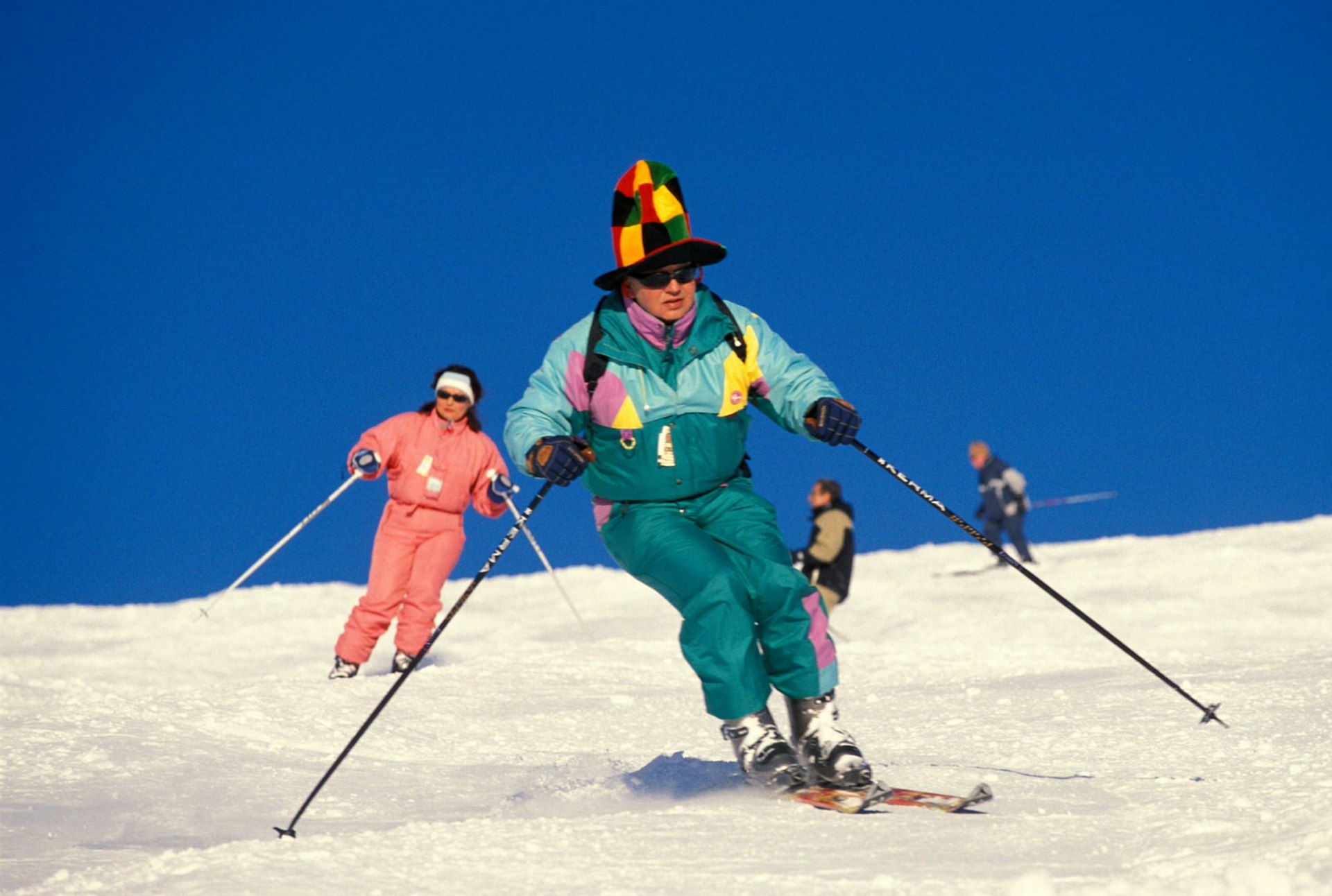 A skier dressed in multicoloured gear heads down a slope near Val Thorens in the French Alps