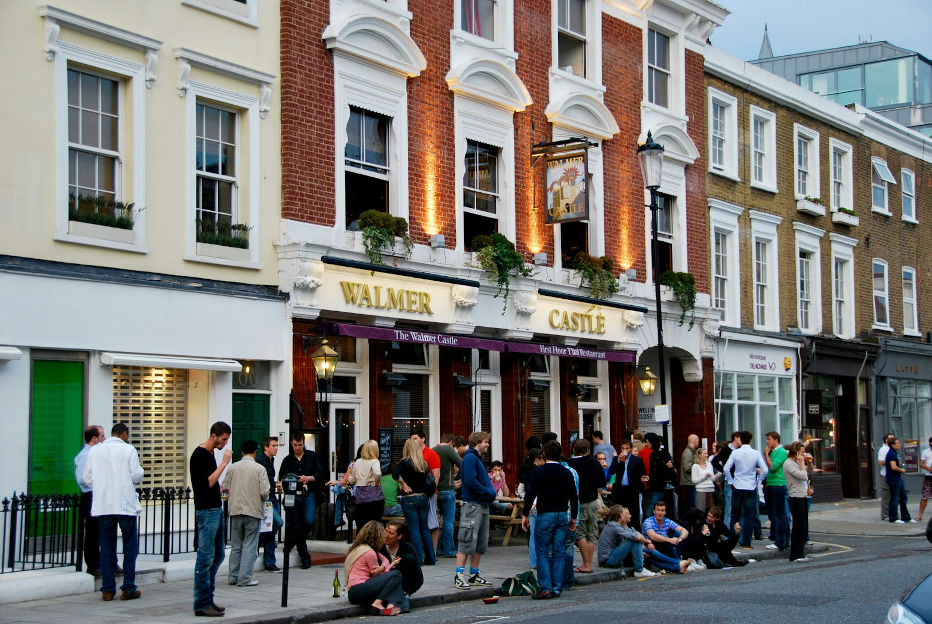 People drinking in the street outside the Walmer Castle pub