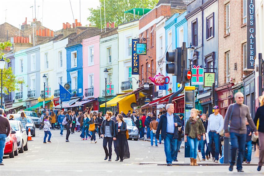 Notting Hill street scene with people walking past colourful shops
