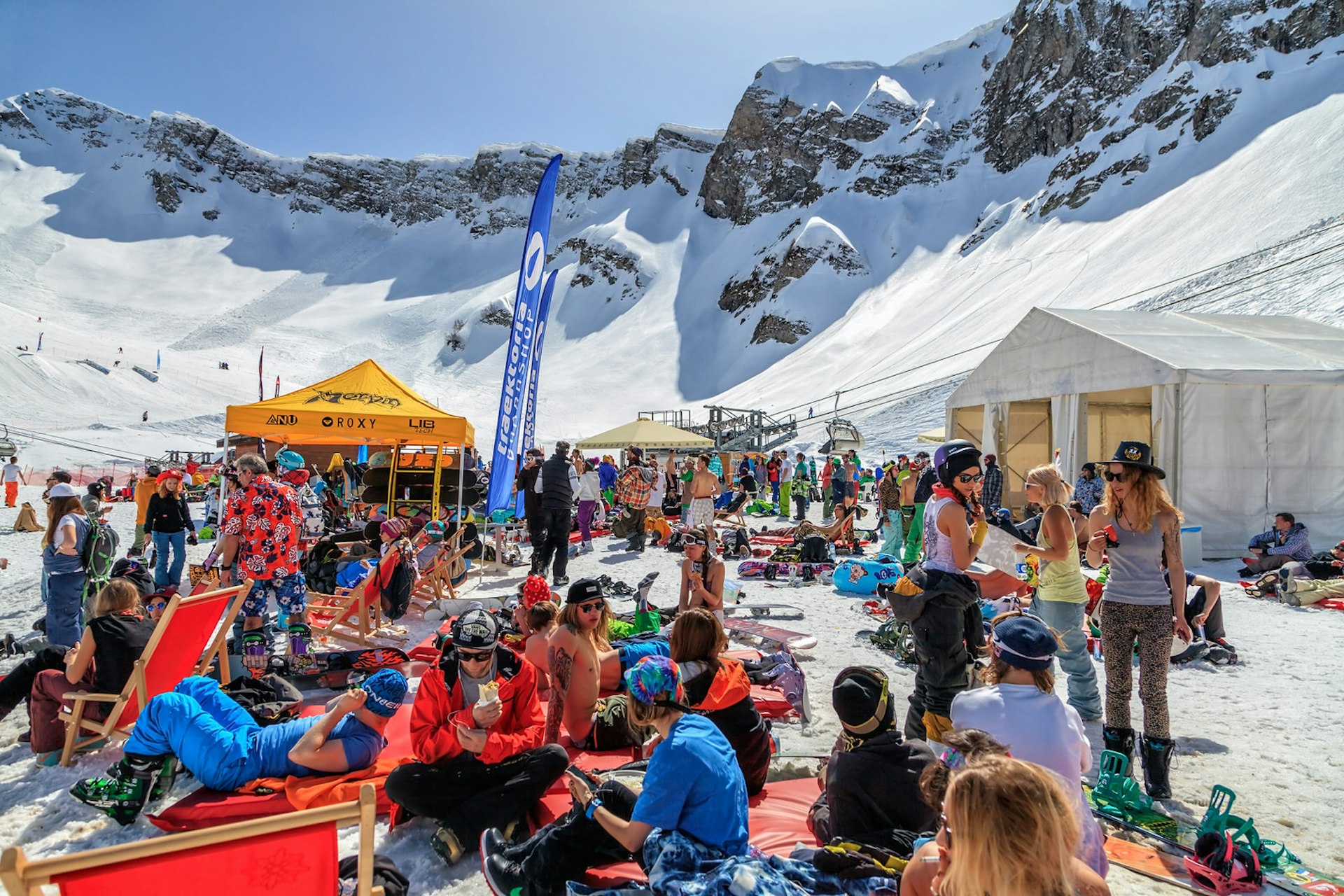A large group of skiers chill out on the snow at a makeshift ski camp in Sochi, Russia