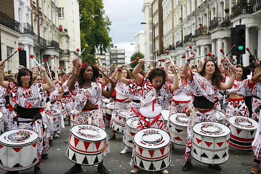 A group of drummers in costume during the Notting Hill Carnival