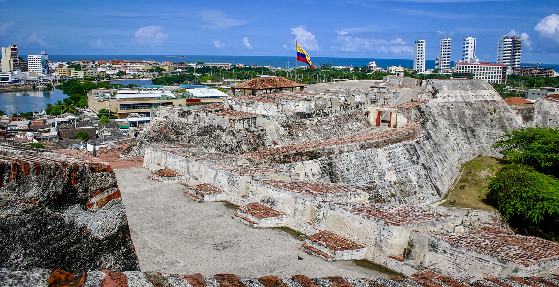 Spanish colonial fort surrounded by modern buildings in Cartagena © Jacqui de Klerk / Lonely Planet