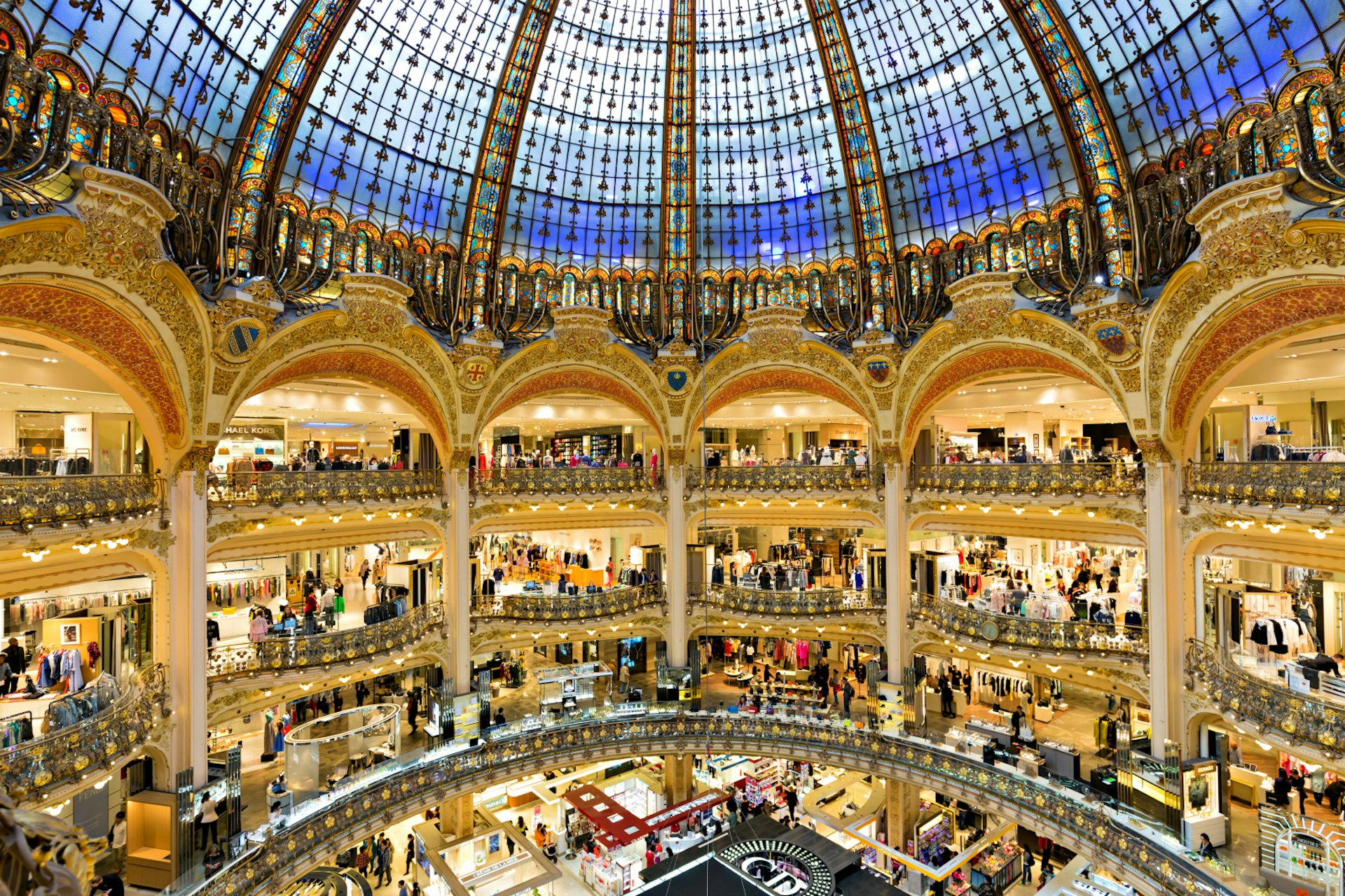 Stores and the famous domed ceiling of Galeries Lafayette in Paris