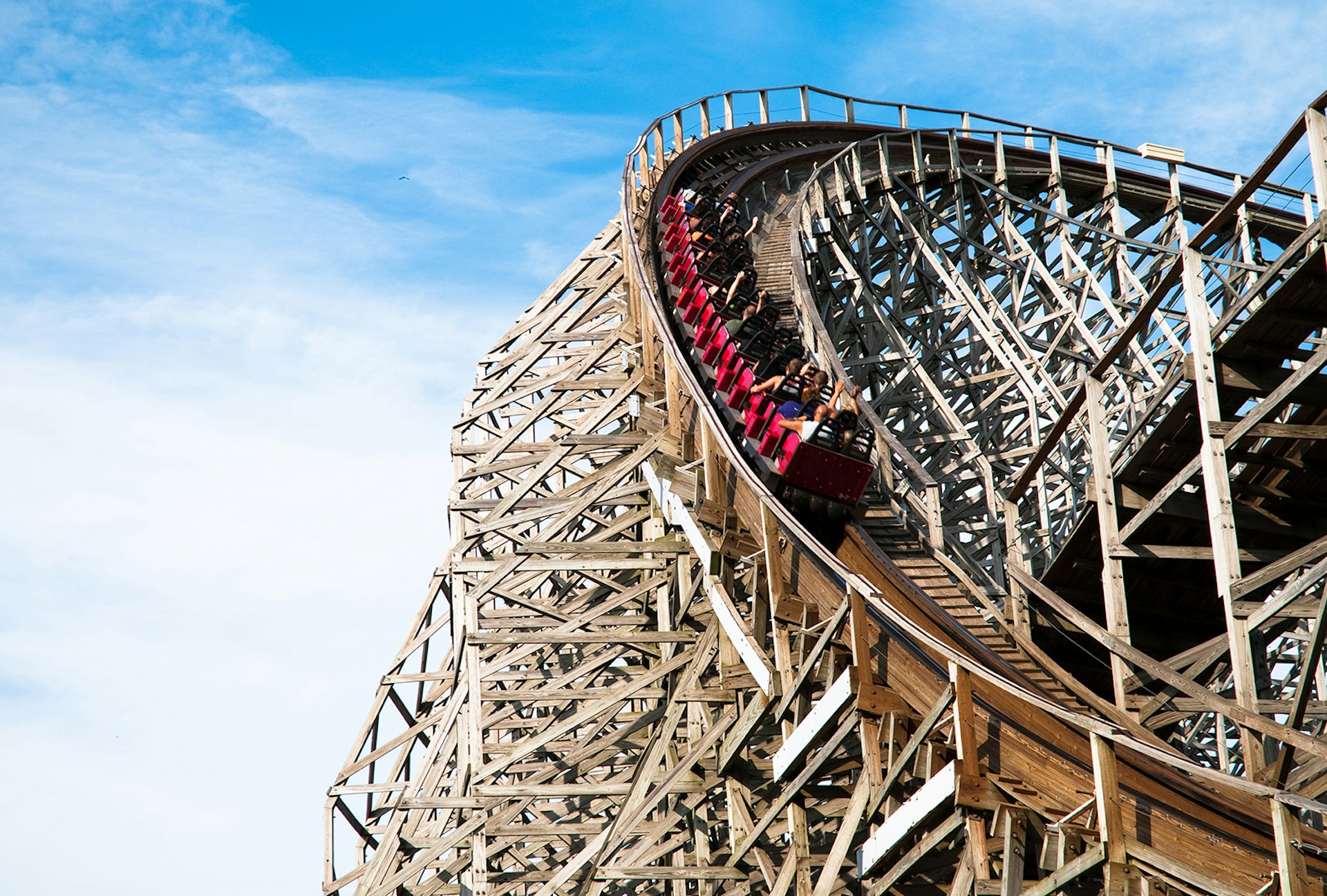 People riding a classic wooden roller coaster at Cedar Point; North America's top amusement parks