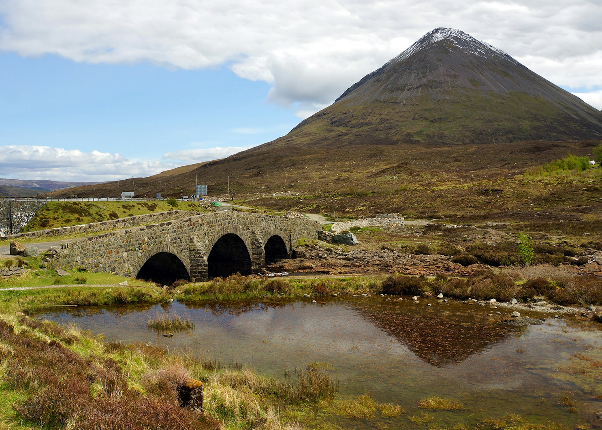 A stone bridge near Sligachan with mountains looming in the background, Isle of Skye © James Kay / Lonely Planet