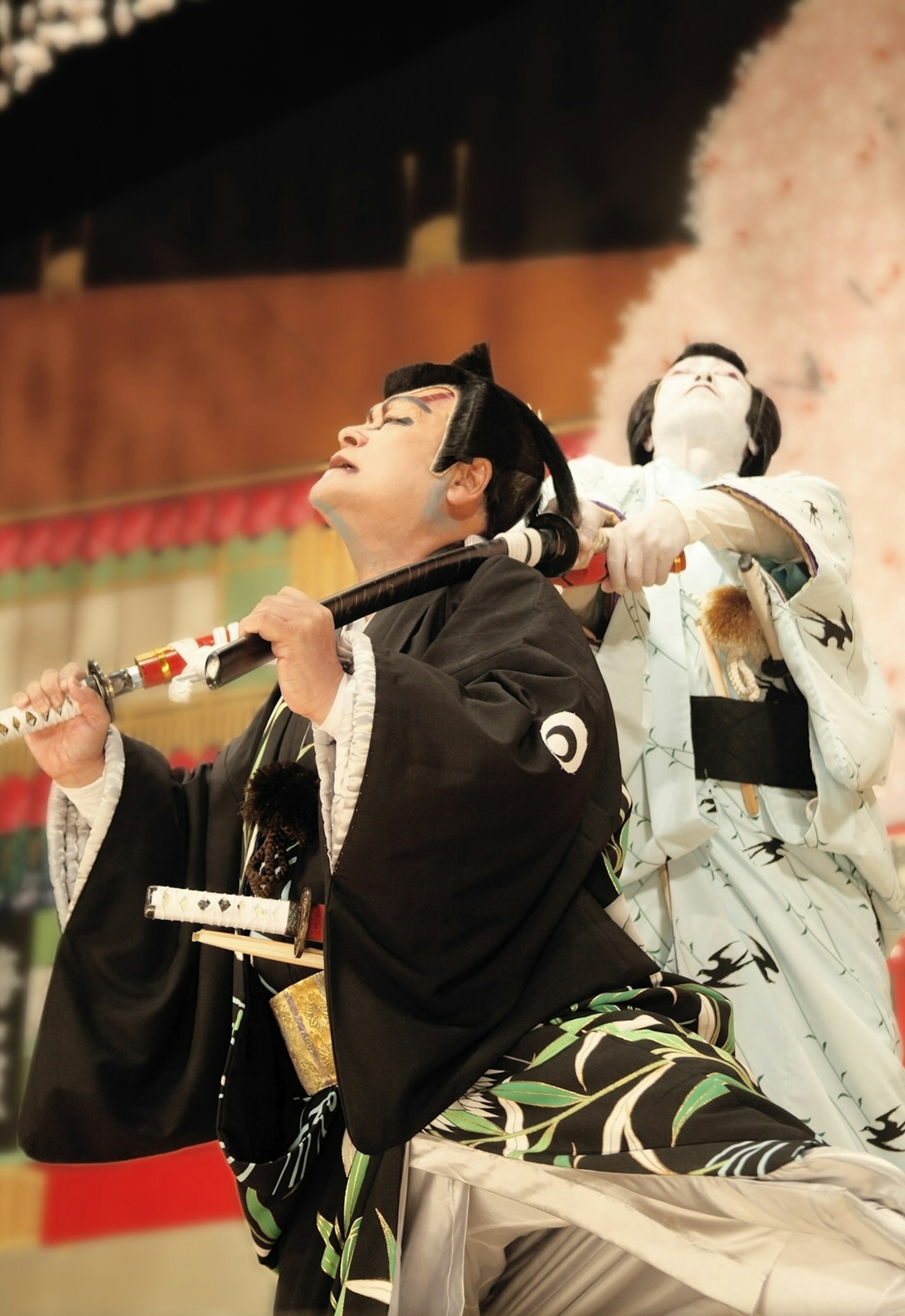 Kabuki actors onstage clash with swords