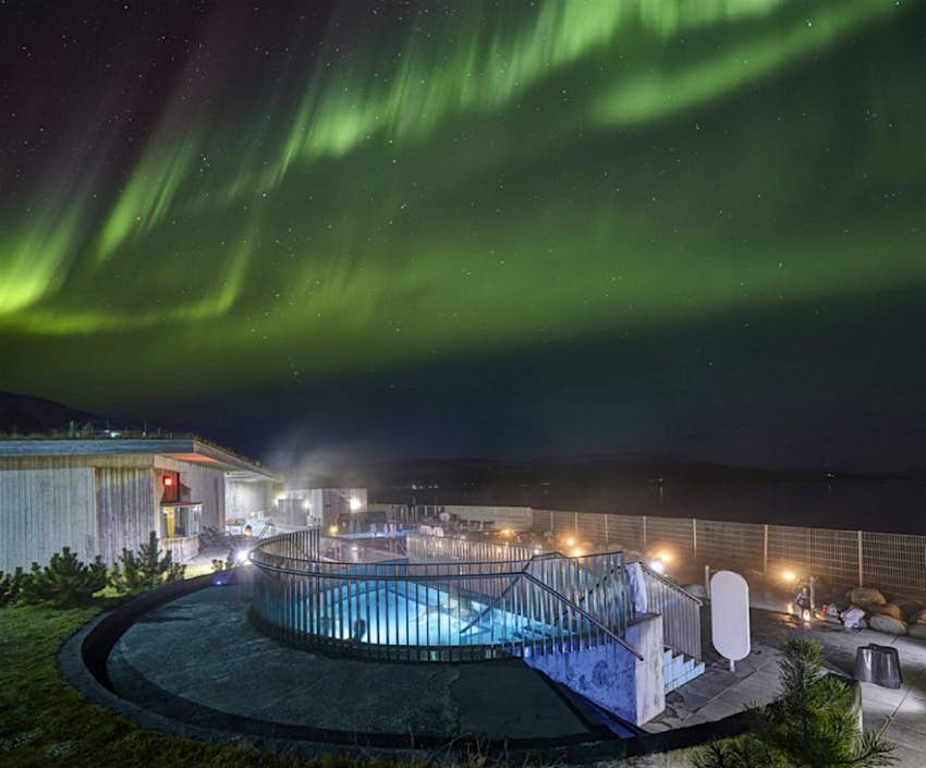 Laugarvatn Fontana outdoor pool with the Northern Lights visible above