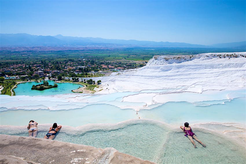 Bathers relax in the terraced hot springs of Pamukkale in Turkey