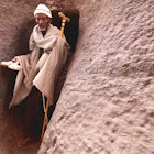 Features - sizedelderly-pilgrim-emerges-from-tunnel-laibela-s