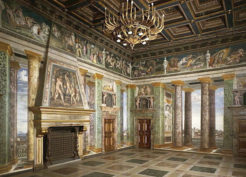 The intricately painted murals on the walls of a villa give the illusion of a much bigger room that looks out to the outside.