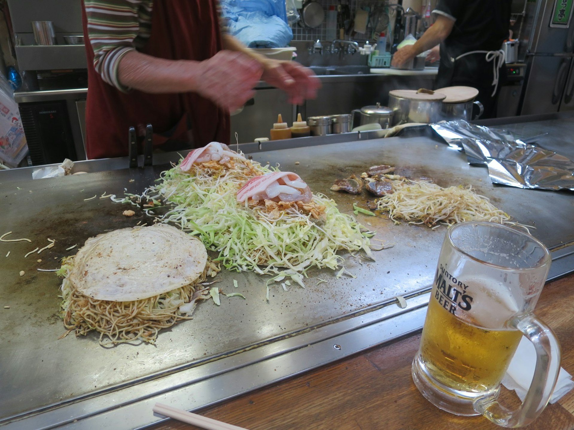 Hiroshima-style okonomiyaki being prepared