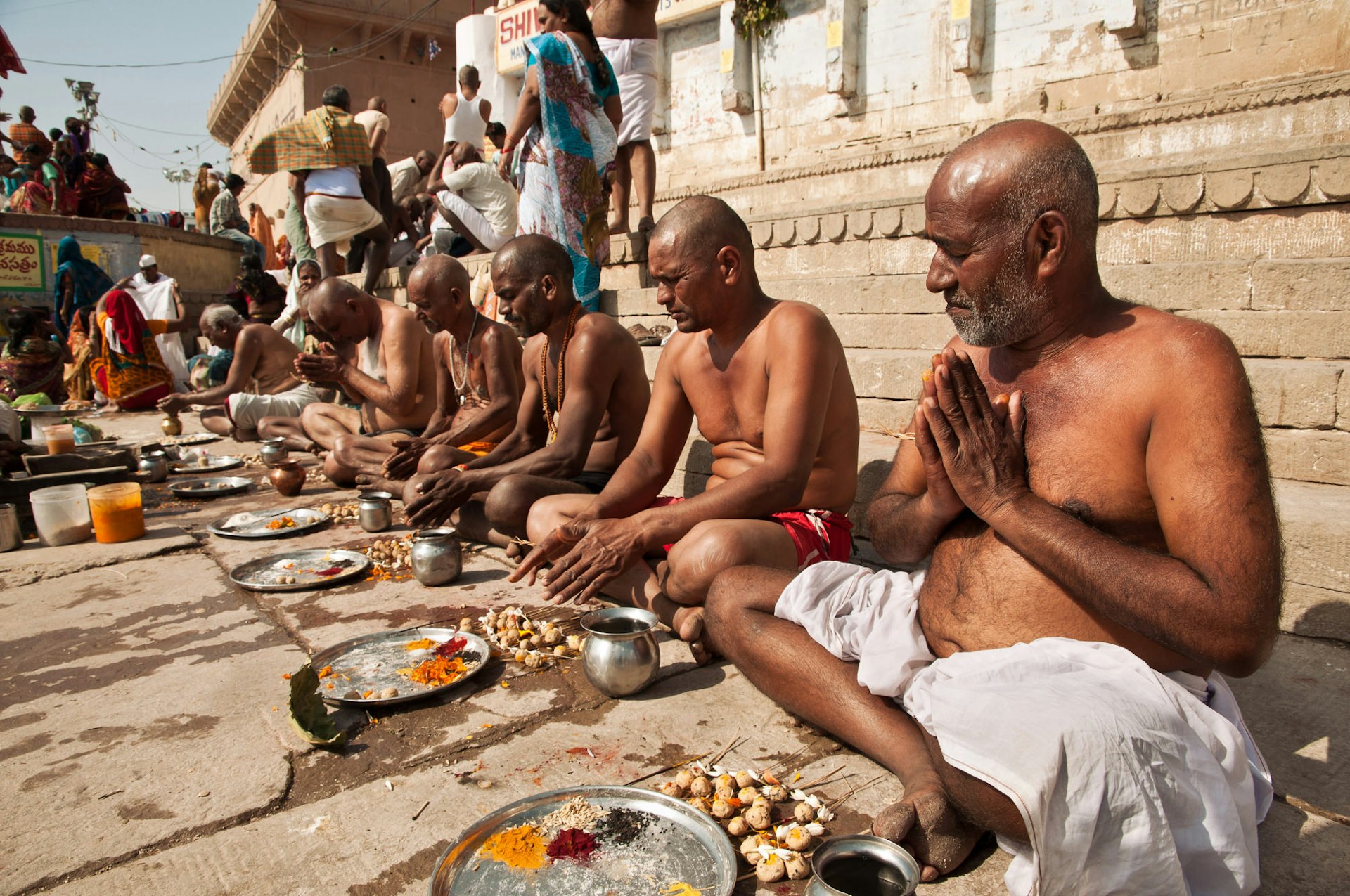Holy men offer blessings beside the River Ganges