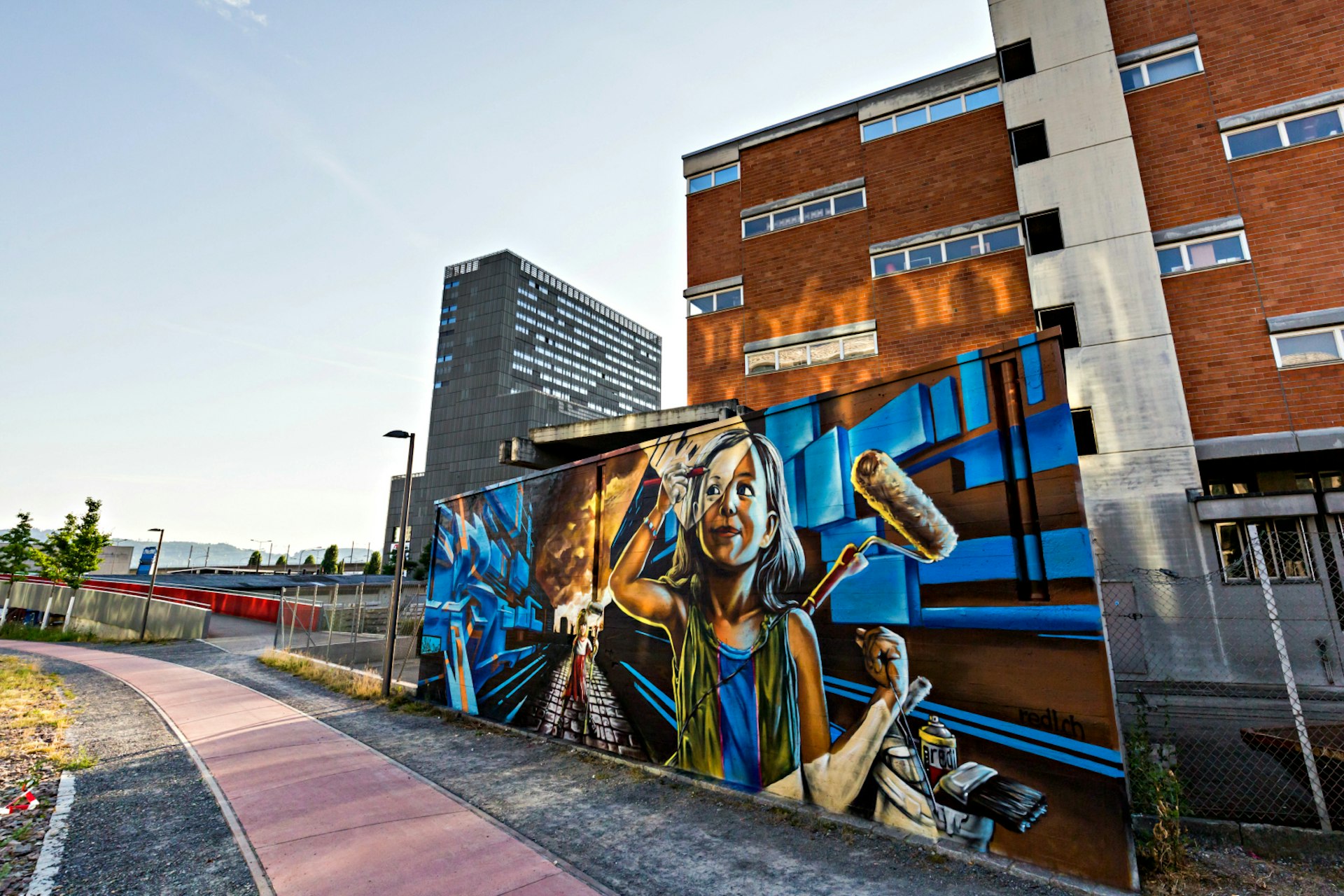 A street art mural in Zürich depicting a female artist painting