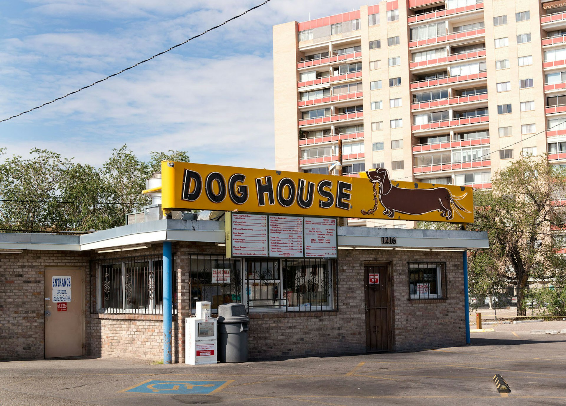 A view of The Dog House restaurant and its sign showing a 'sausage dog' eating sausages 