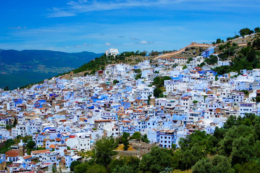 Beautiful city of Chefchaouen, Morocco, built on a hill slope. Houses are painted blue and white, which adds to the uniqueness of this city. Image by Ken Yew / Getty Images