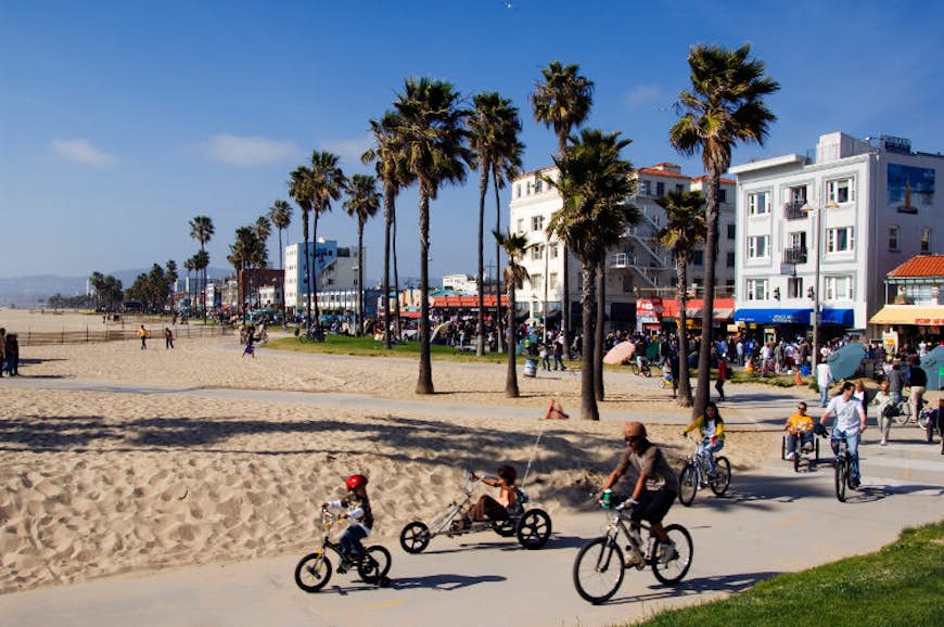 Venice Beach is popular for outdoor activities including cycling. Image by Christian Kober / Getty